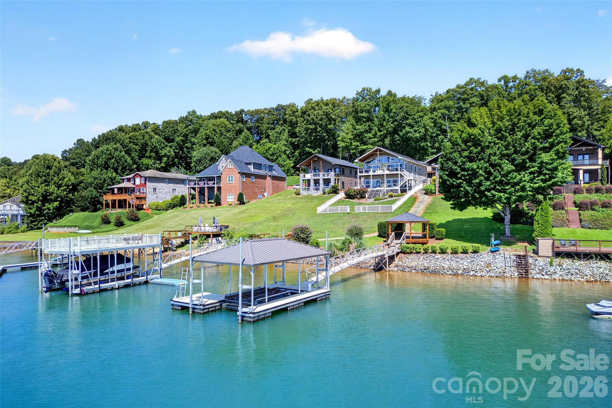 Aerial of the Marion Lake Club shoreline showing neighboring docks and the peninsula setting. - 831 Lake Club Drive, Nebo