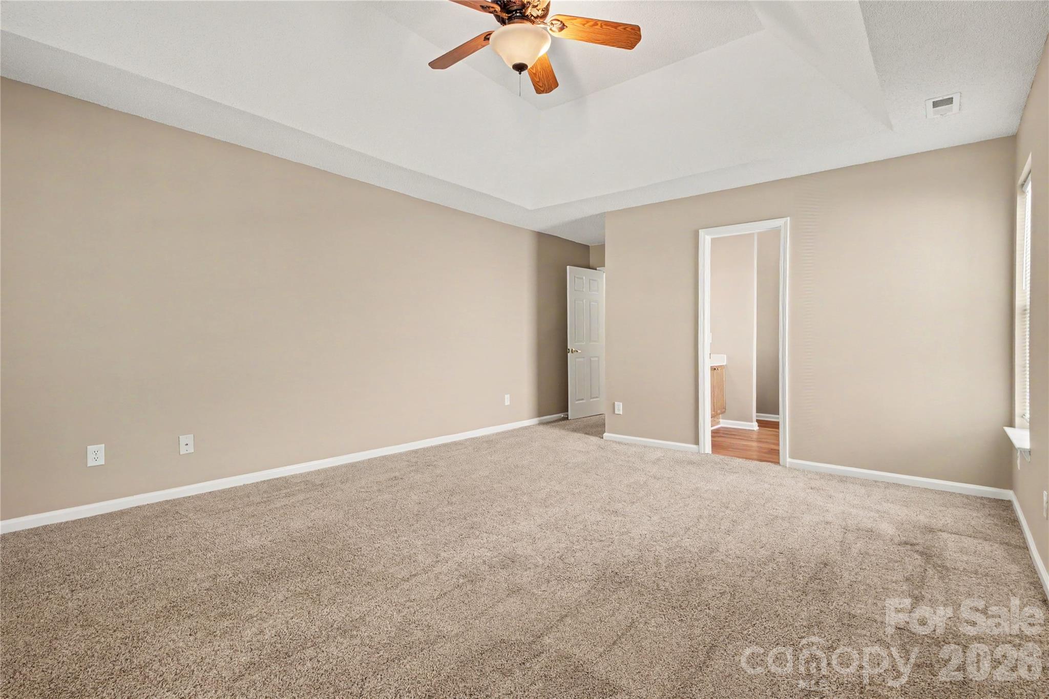 Primary bedroom with trey ceiling and fan - 3786 Sedgewick Street SW, Concord