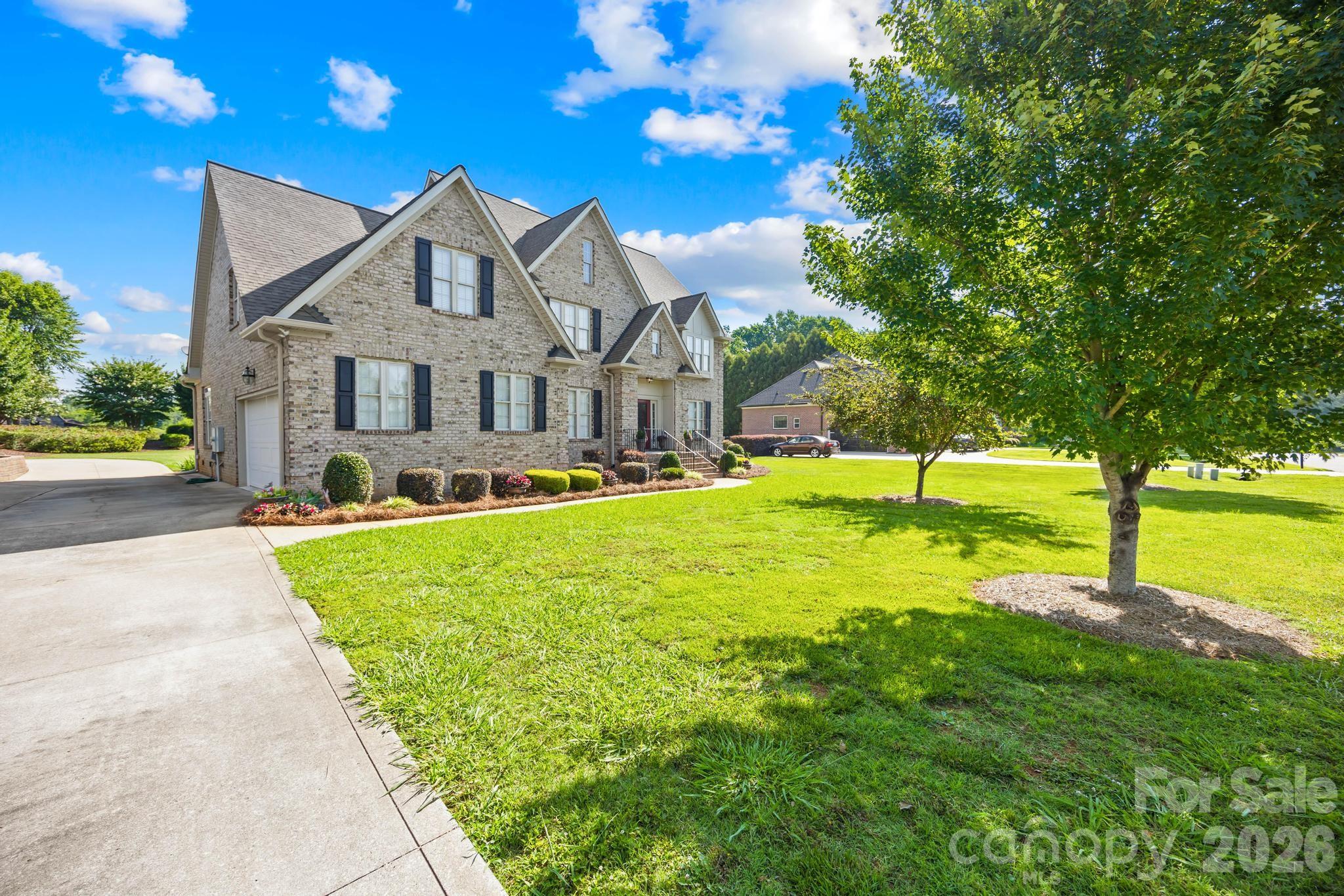 Front view of home with side load garage. Easy access in and out of property with circle drive - 105 Mandarin Drive, Mooresville