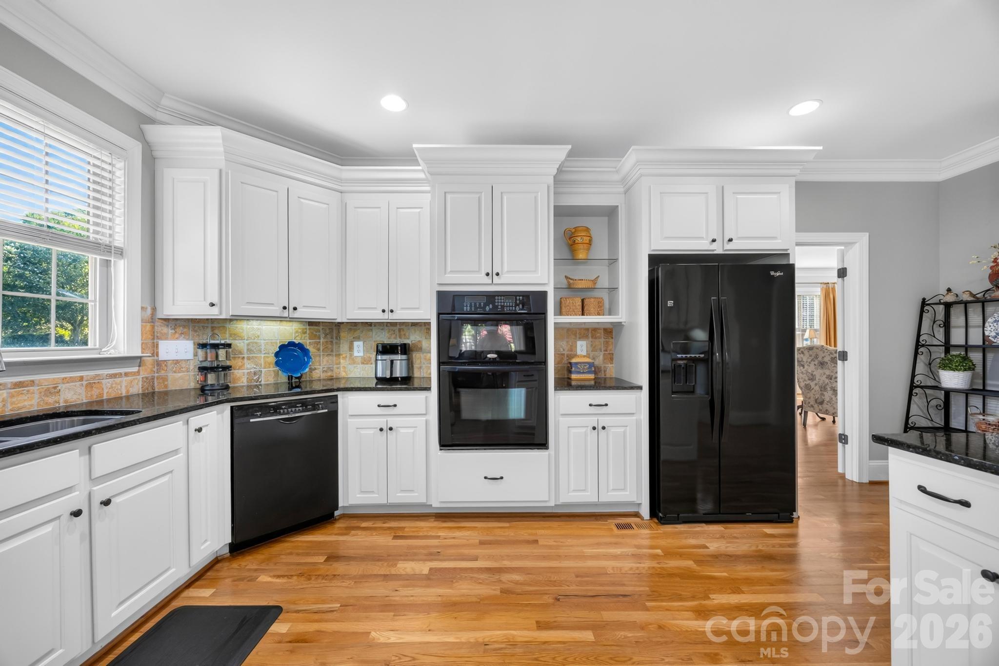 Kitchen with double ovens, undermount lights, and refrigerator with ice/water dispenser - 105 Mandarin Drive, Mooresville