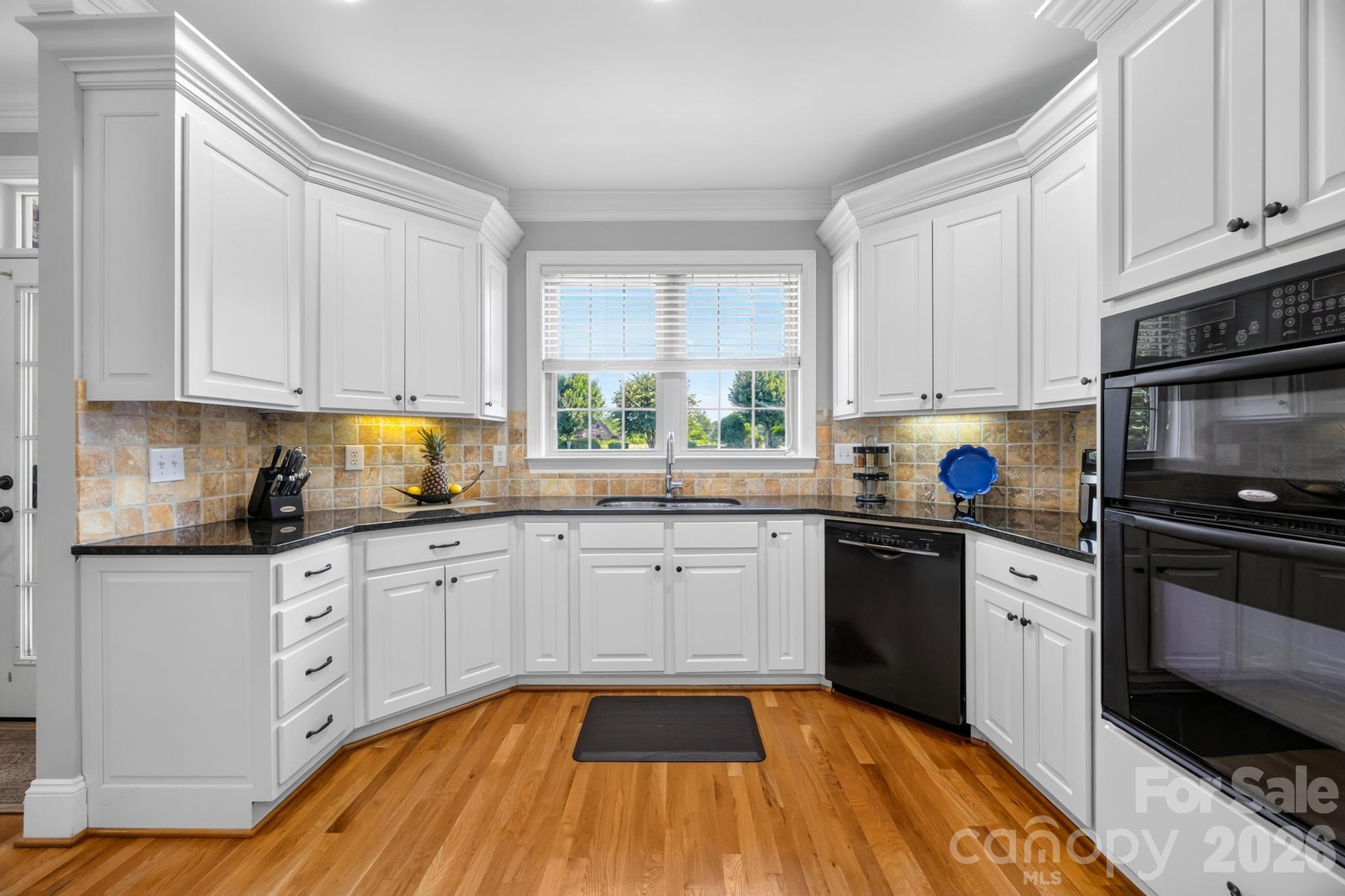 Kitchen-black granite countertops and white cabinets - 105 Mandarin Drive, Mooresville