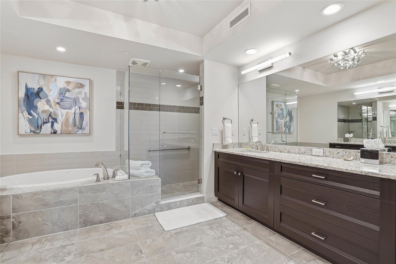 Luxurious primary bath with dual vanities, soaking tub, and walk-in shower. - 650 COLLANY RD #401, TIERRA VERDE