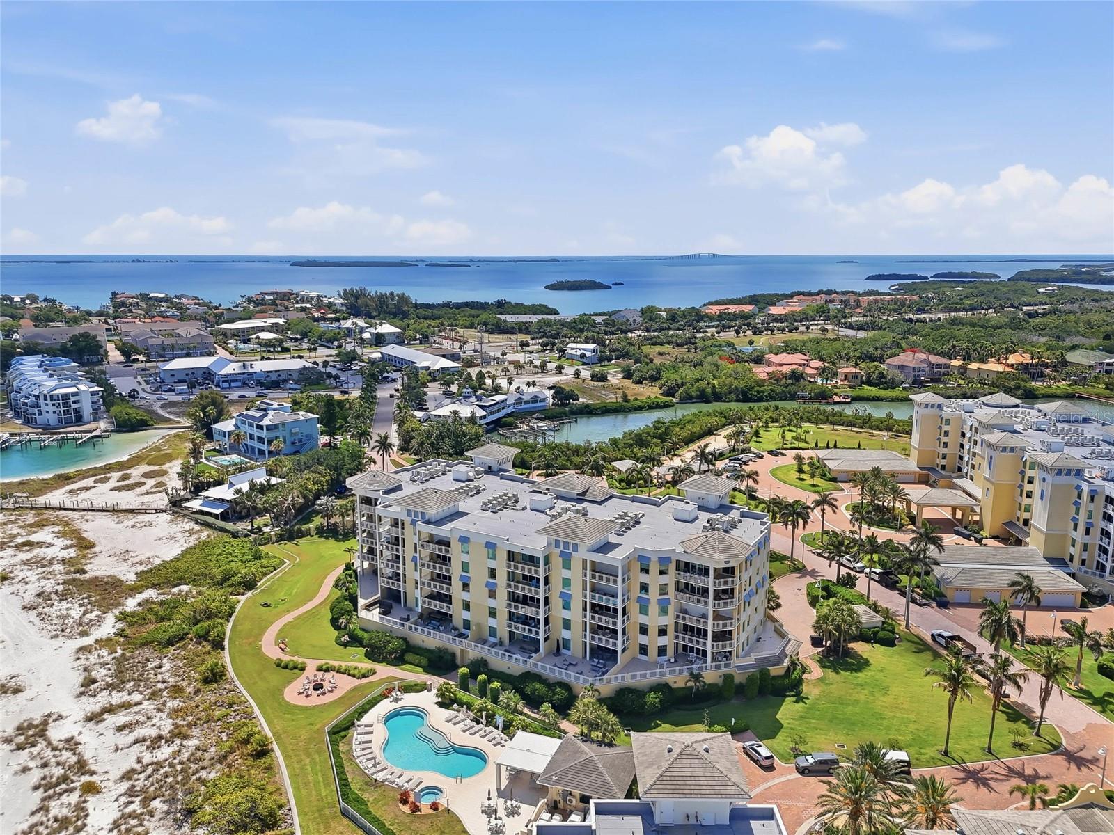 Aerial view highlighting the beachfront location and resort-style pool. Tierra Verde and the beaches close to Fort Desoto is an amazing Paradise! Live here now! - 650 COLLANY RD #401, TIERRA VERDE