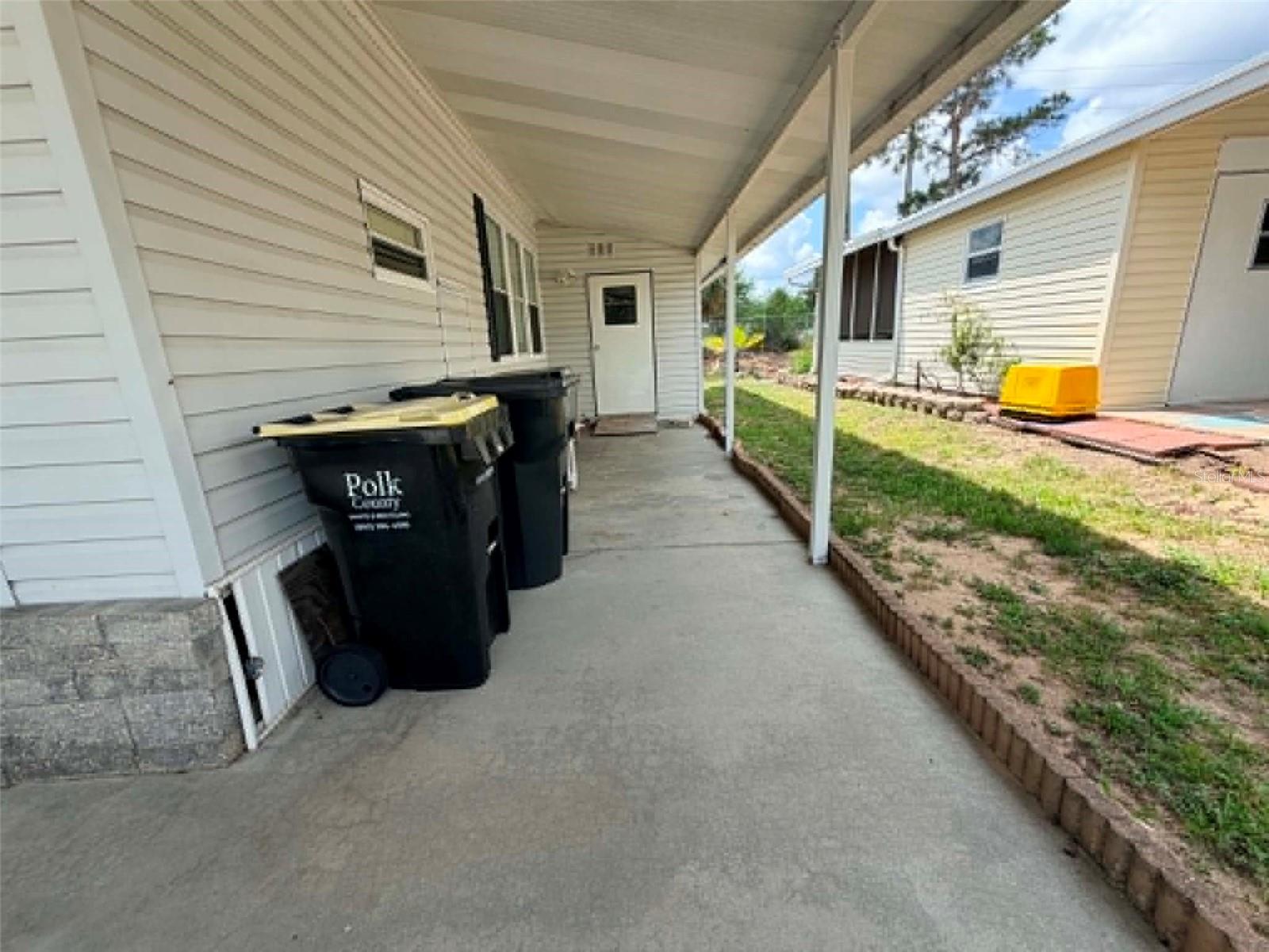 right side of house leading to utility room - 50989 HIGHWAY 27 #87, DAVENPORT