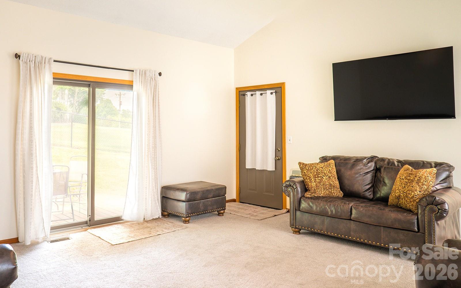 Family Room with sliding Doors to the patio and fenced back yard. - 100 Forest Park Drive, Hendersonville