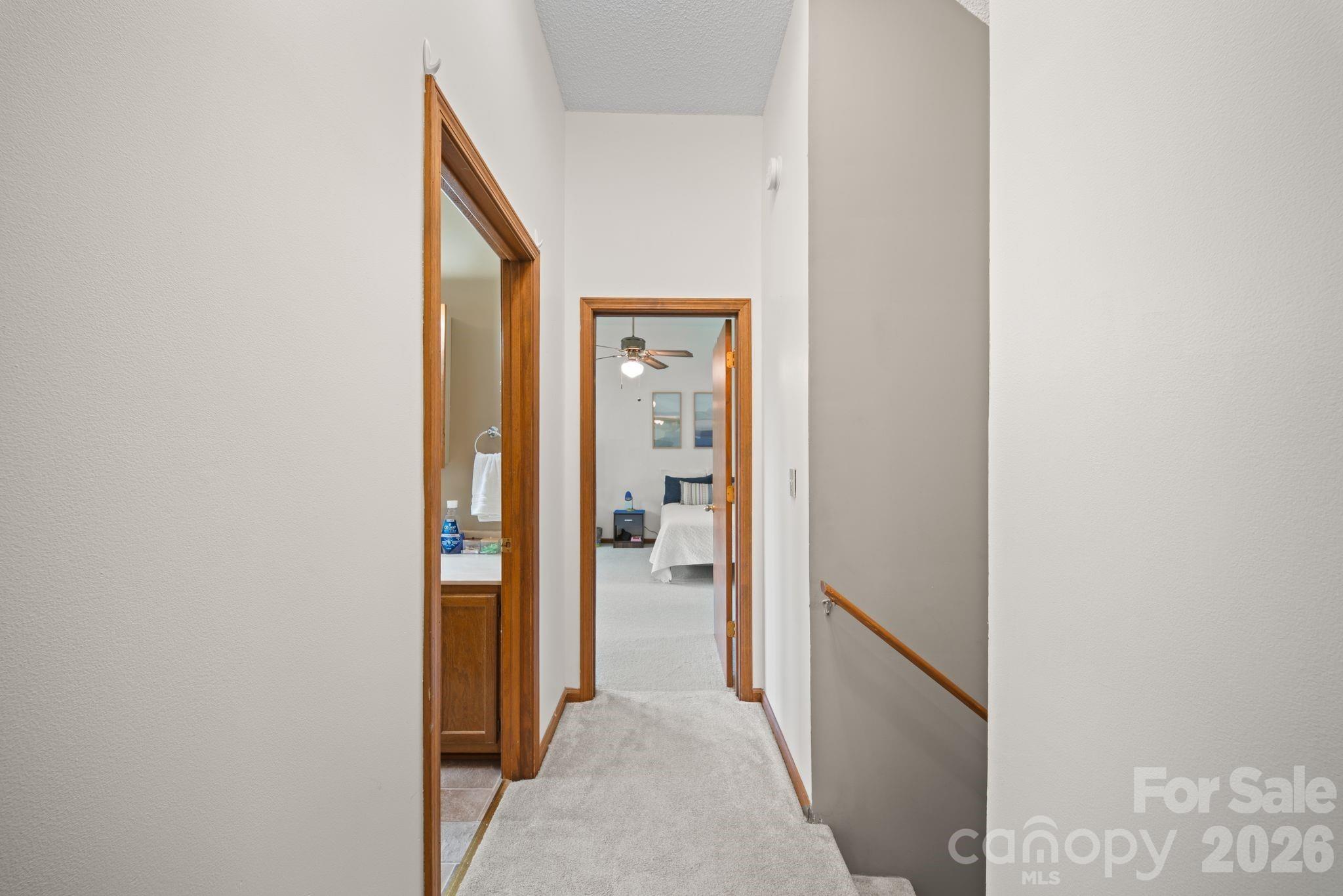 Upstairs hallway leading to full bath and second bedroom on that level - 100 Forest Park Drive, Hendersonville