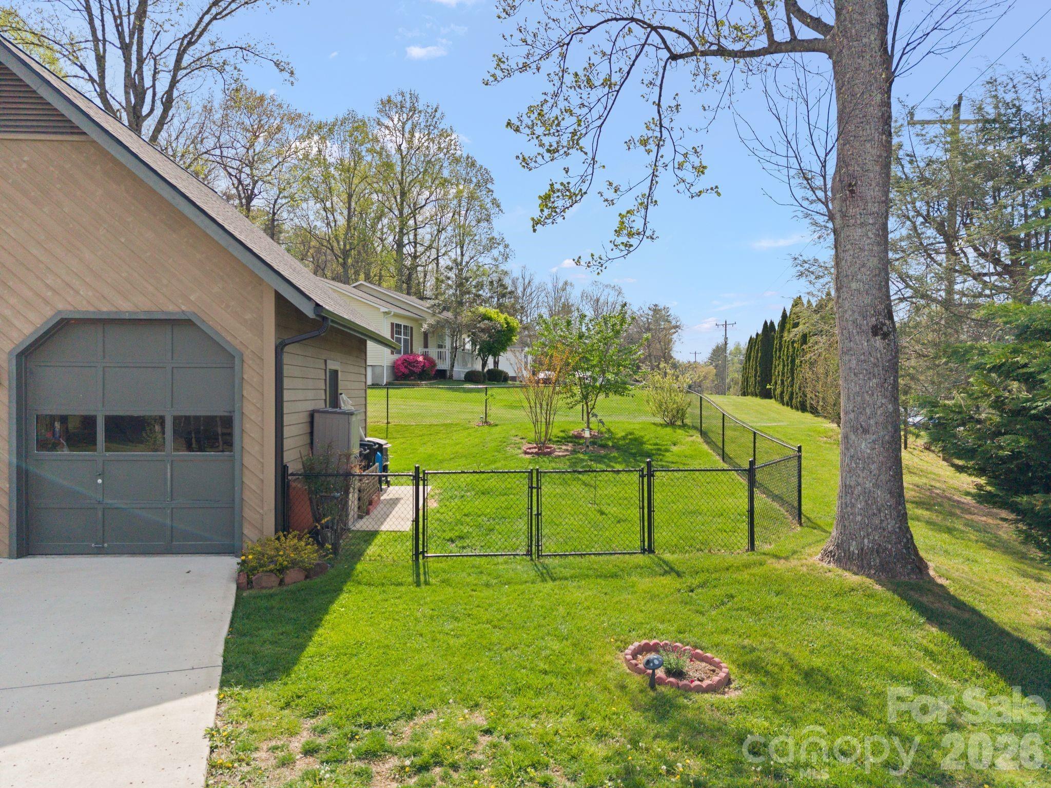 Fully fenced back yard with gate for mower access. - 100 Forest Park Drive, Hendersonville