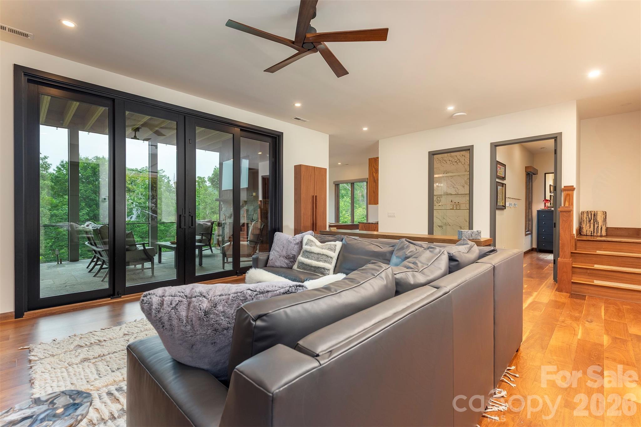 Lower level media room with walk out screened deck with fireplace - 158 Riverbend Forest Drive, Asheville