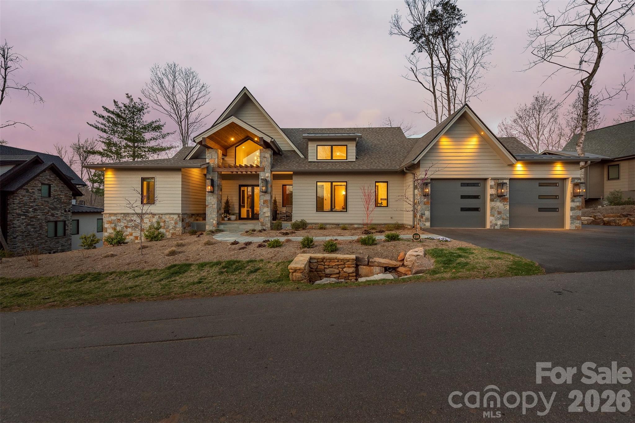 Gas lights on the exterior adds to the beauty of this home - 158 Riverbend Forest Drive, Asheville