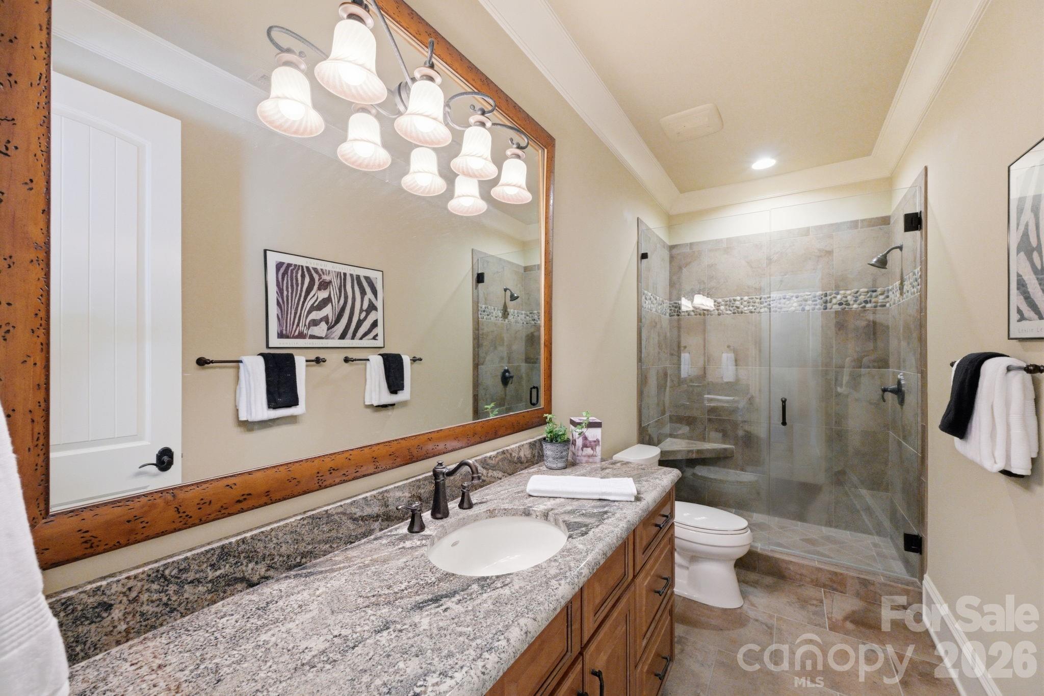 Guest suite 1 with frameless glass, tile and pebble shower - 8528 Waxhaw Creek Road, Waxhaw