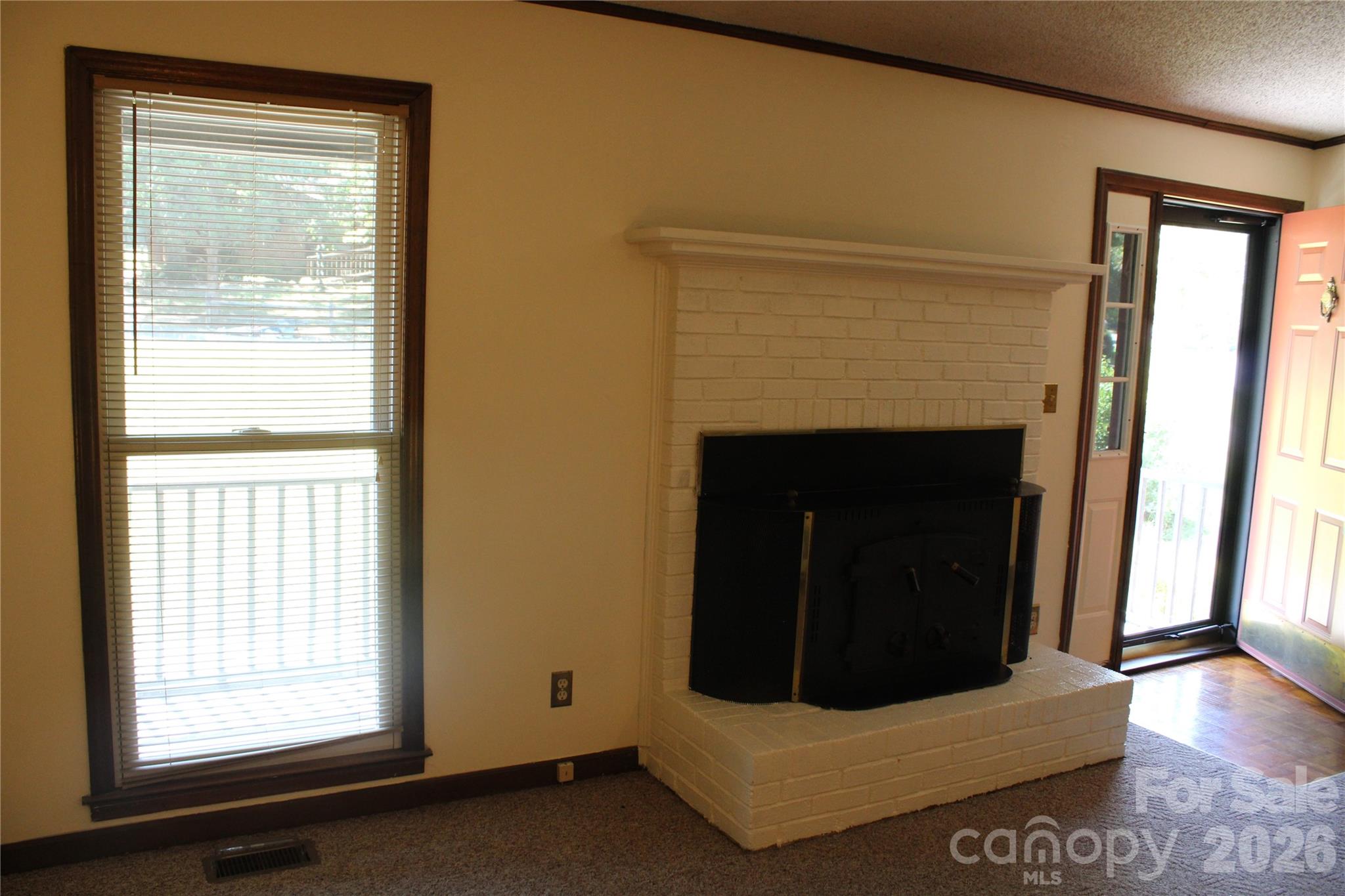 Great room has fireplace with wood stove - 1841 Oak Hollow Road, Gastonia