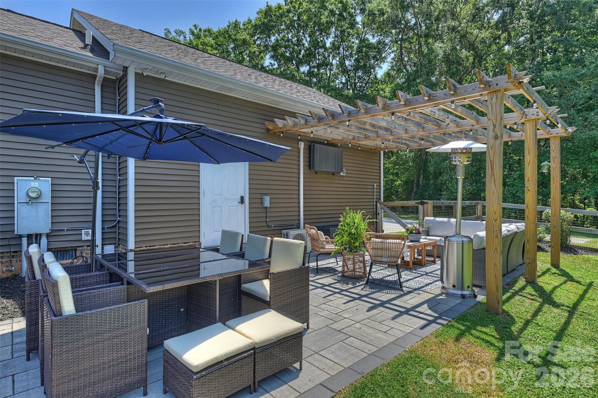 Outdoor living space adjacent to the air conditioned garage creates flexible entertainment space any time of the year. - 10943 Harrisburg Road, Indian Land