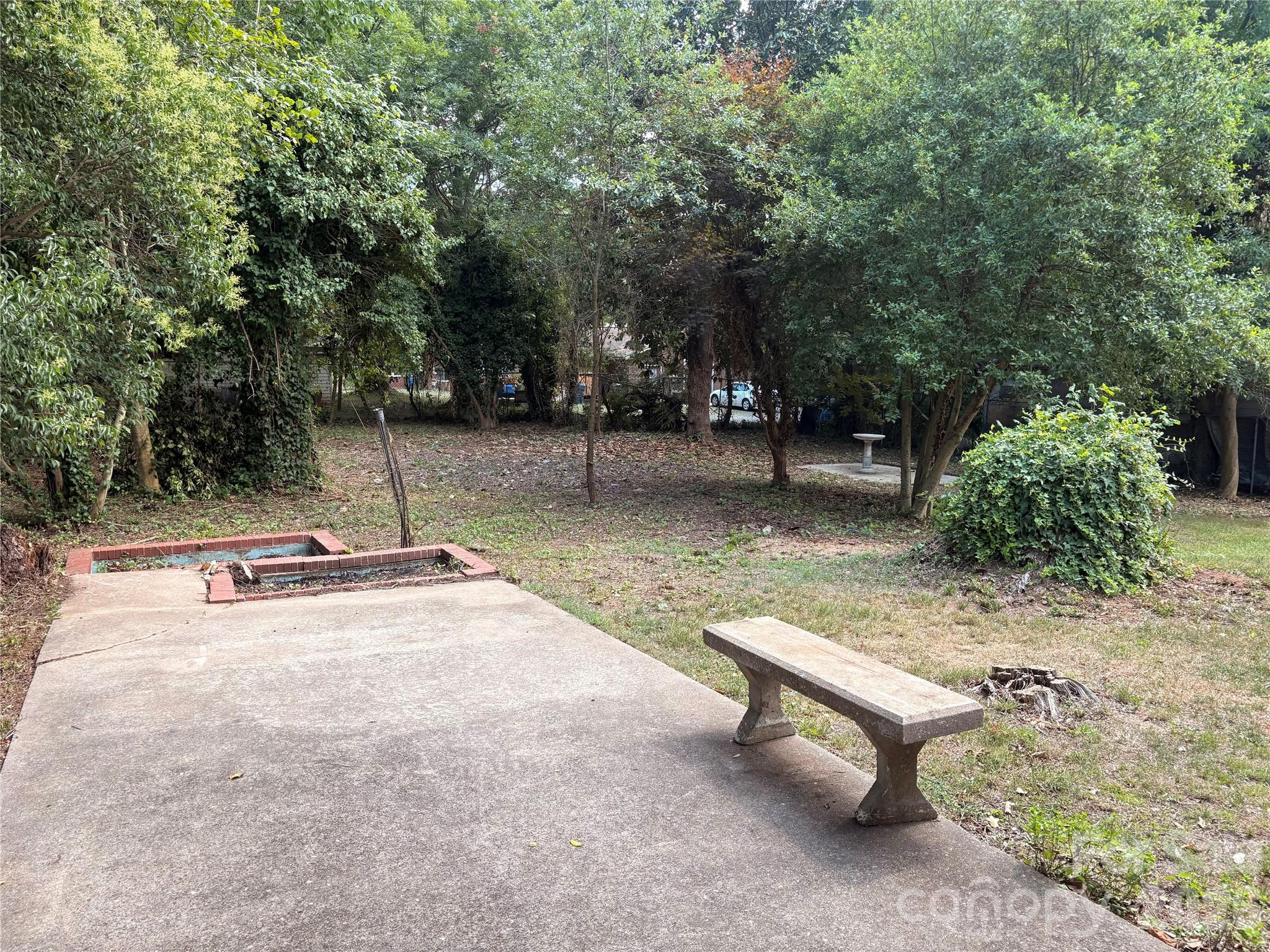 Backyard with concrete patio.Please watch your step next to the vacant koi pond - 725 5th Avenue SW, Hickory