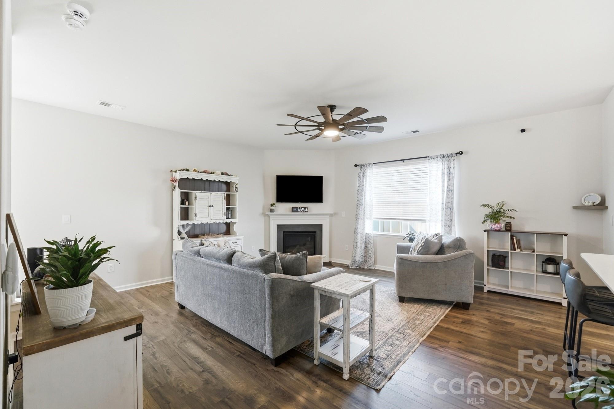 Natural light fills this inviting living space centered around a cozy gas fireplace. - 170 Giant Oak Avenue, Statesville