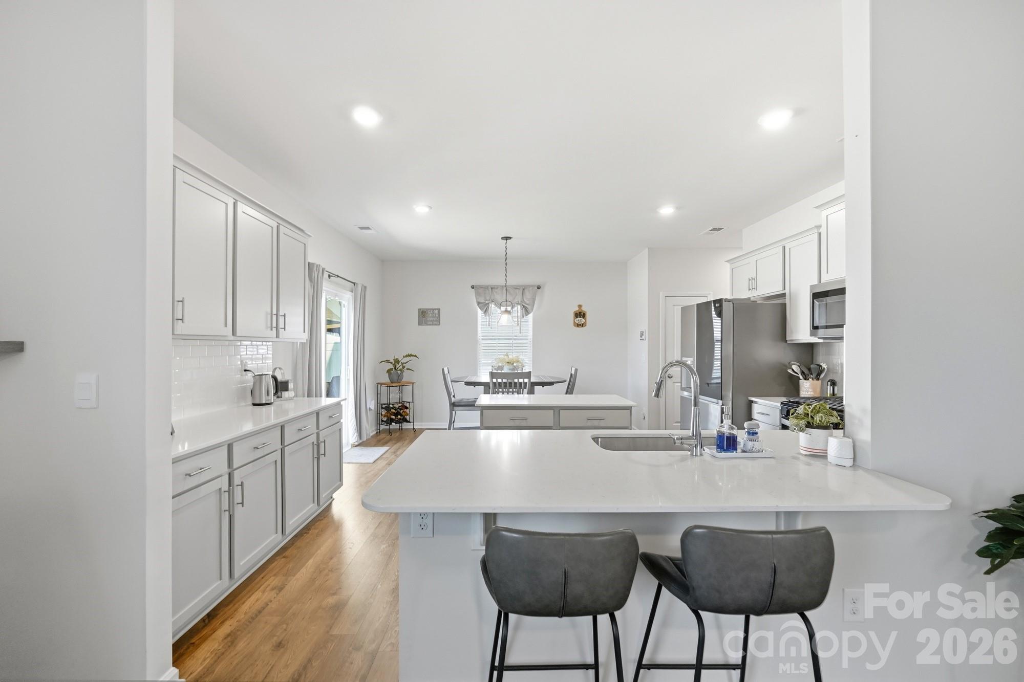 The oversized island offers plenty of seating for family and guests. - 170 Giant Oak Avenue, Statesville