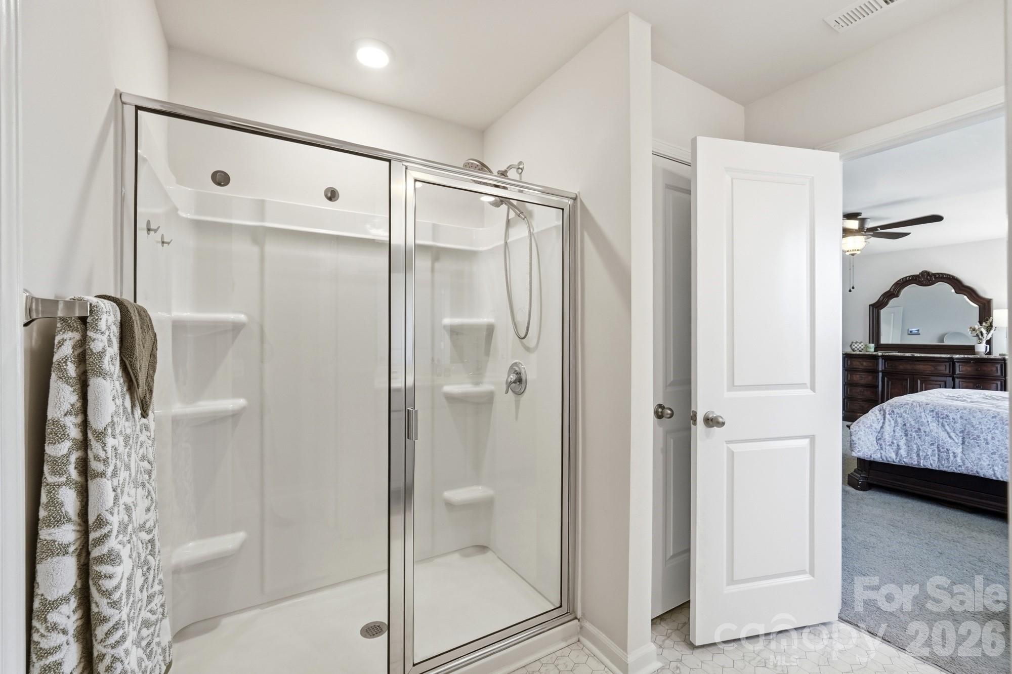 A spacious walk-in shower complements the relaxing primary bath. - 170 Giant Oak Avenue, Statesville