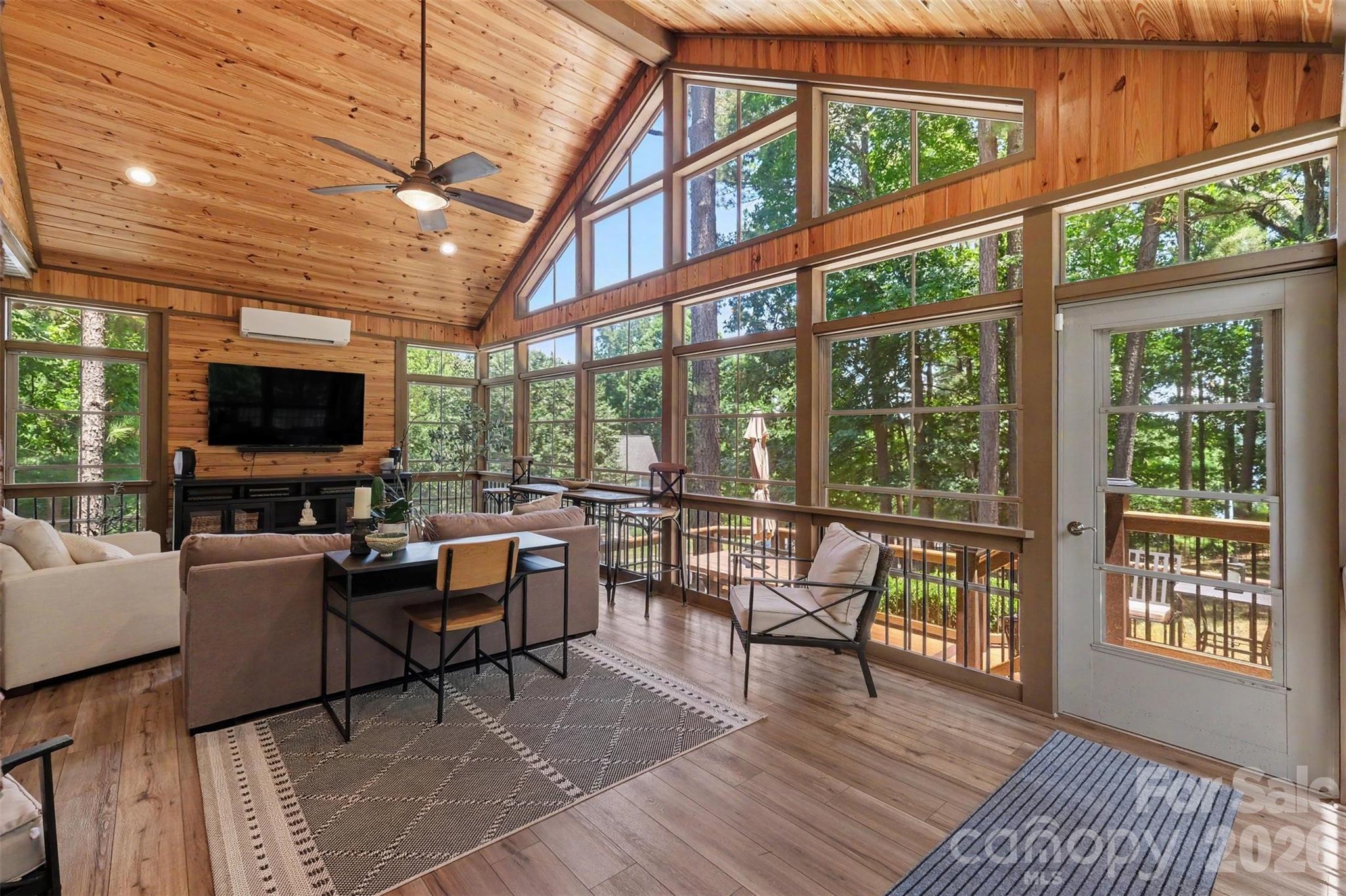 Vaulted pine ceiling, expansive windows, and tranquil views define this light-filled retreat. - 109 Whiterock Drive, Mount Holly