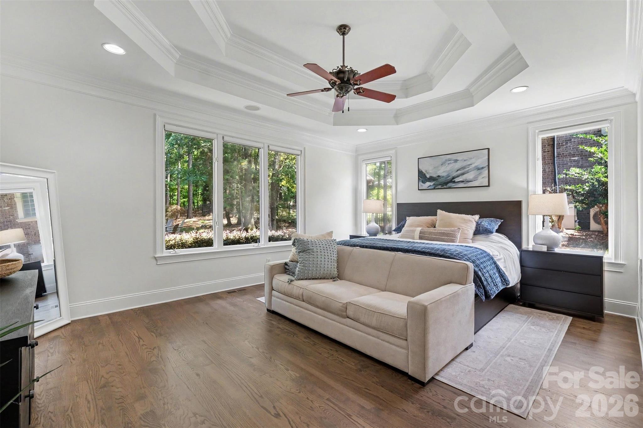 Main level primary suite with decorative double tray ceiling, and 2 separate walk-in closets, one with custom built-ins. - 109 Whiterock Drive, Mount Holly