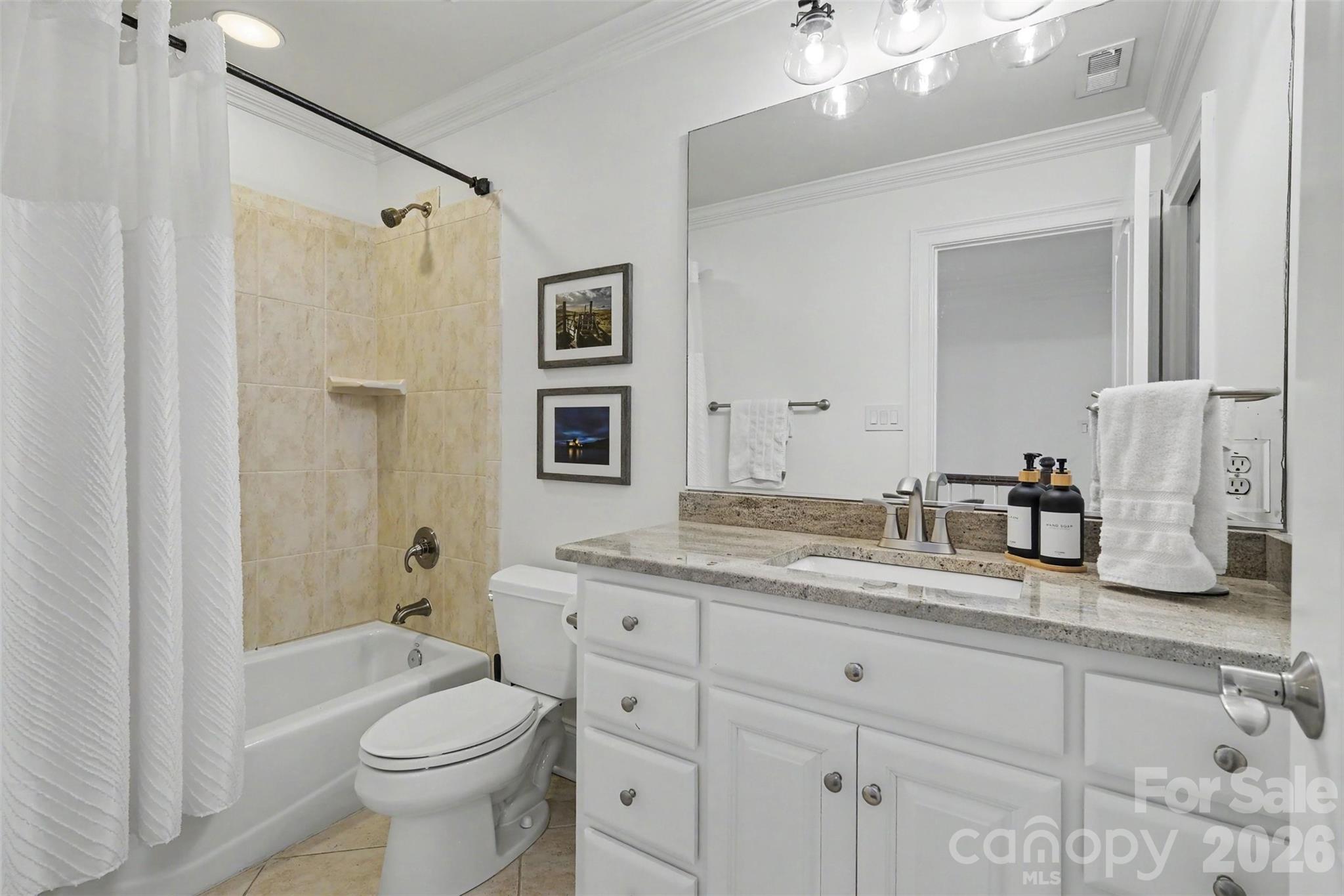 Secondary baths with granite countertops, tile flooring, bathtub with tile surrounsds, and updated fixtures. - 109 Whiterock Drive, Mount Holly