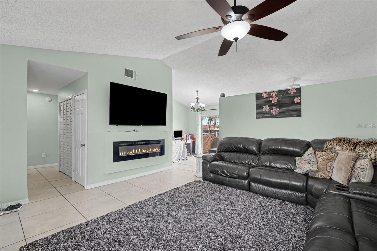 Living room. 75" TV stays. Also featured is an electic fireplace - 13238 FOWLER AVE, PORT CHARLOTTE