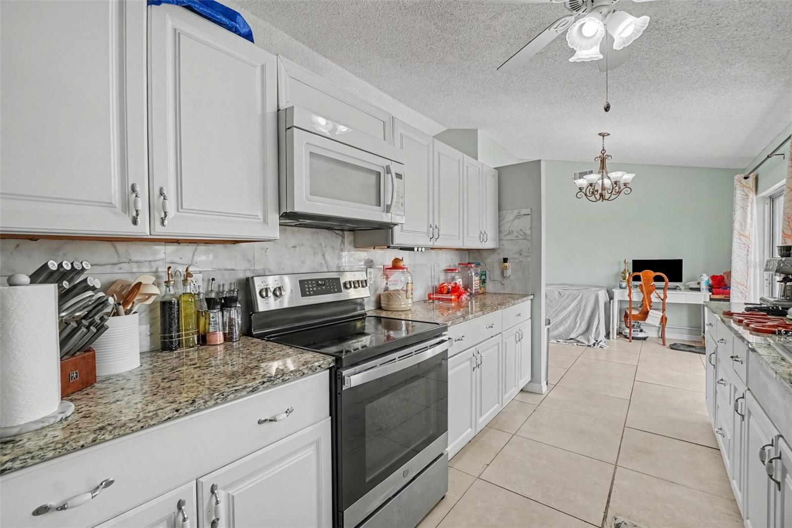 Galley kitchen with stone counters - 13238 FOWLER AVE, PORT CHARLOTTE