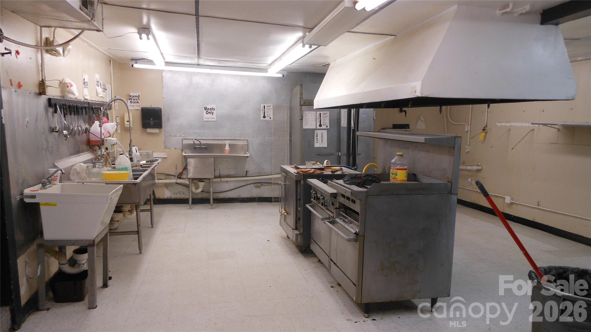 Rear area of kitchen with sinks, exhaust hood, & gas grill - 1553 S Battleground Avenue, Kings Mountain