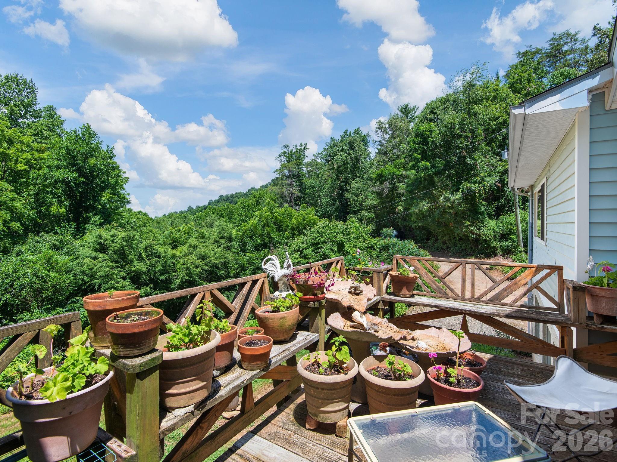 Built-in benches on this sweet balcony- accessible from the kitchen dining area and the primary bedroom - 46 Perennial Ridge, Weaverville