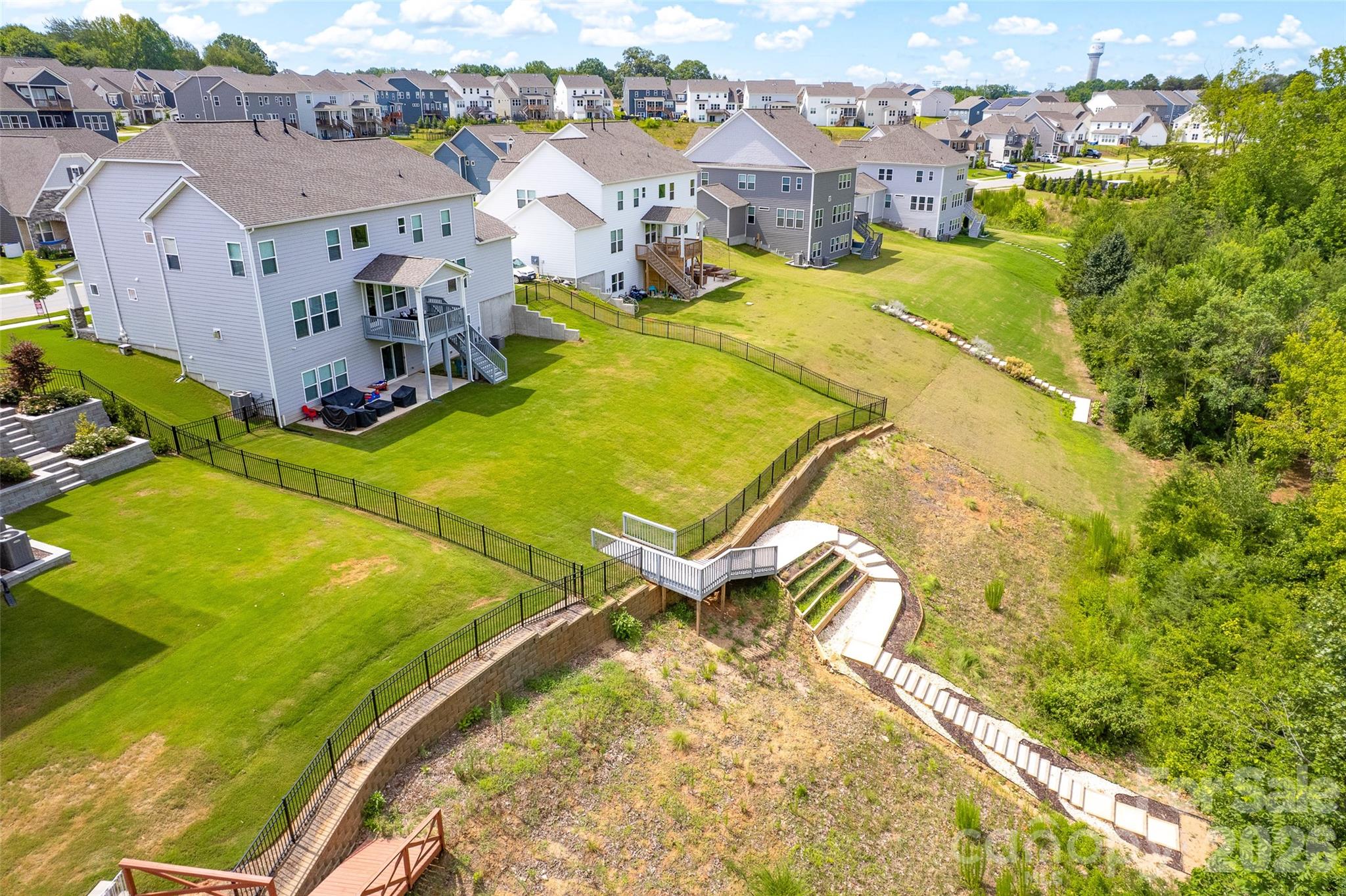 view of the fenced back yard and access to the lake - 309 W Waterlynn Road, Mooresville