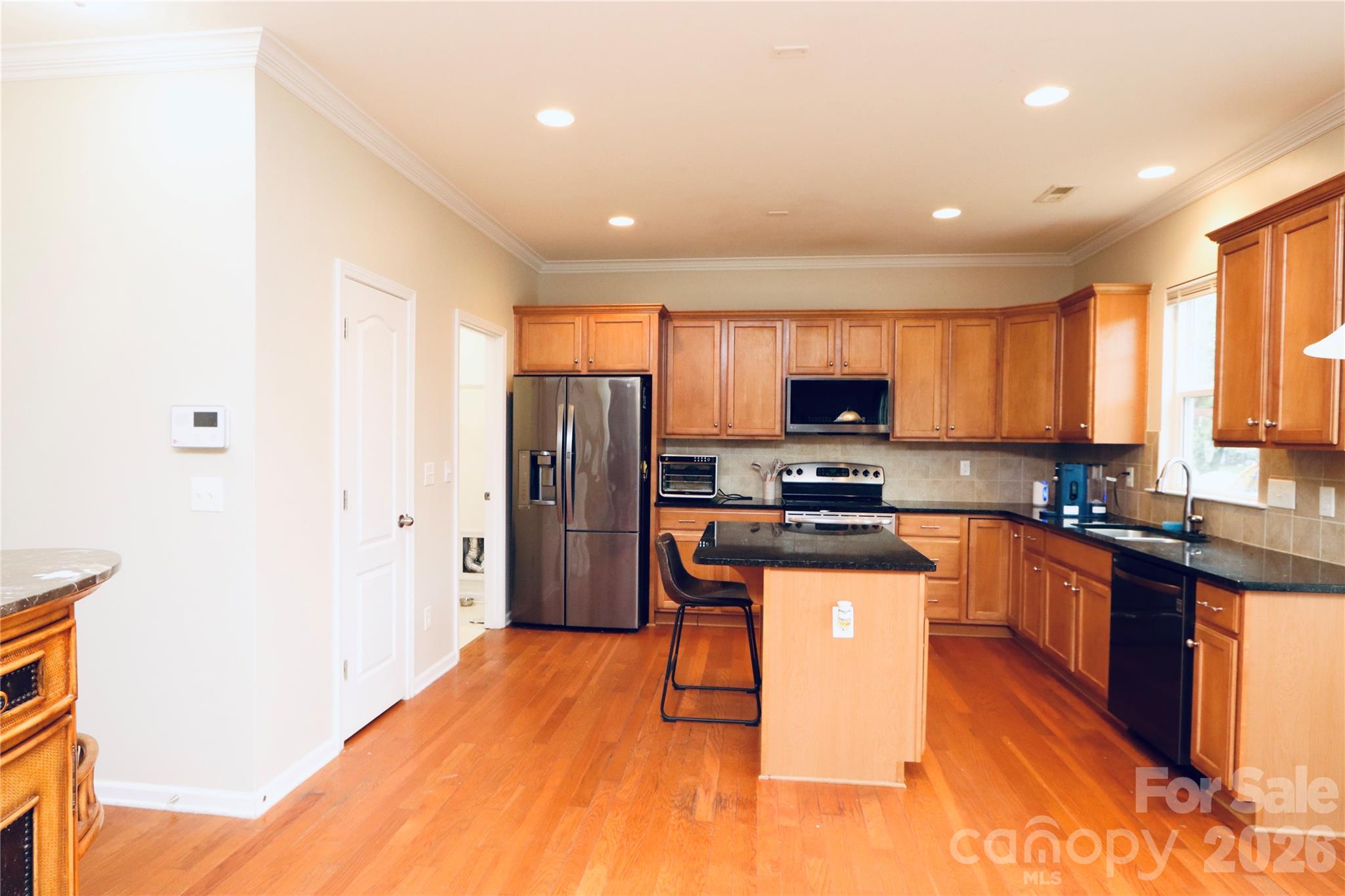 Large kitchen with island & stainless steel appliances - 3586 Larkhaven Avenue SW, Concord