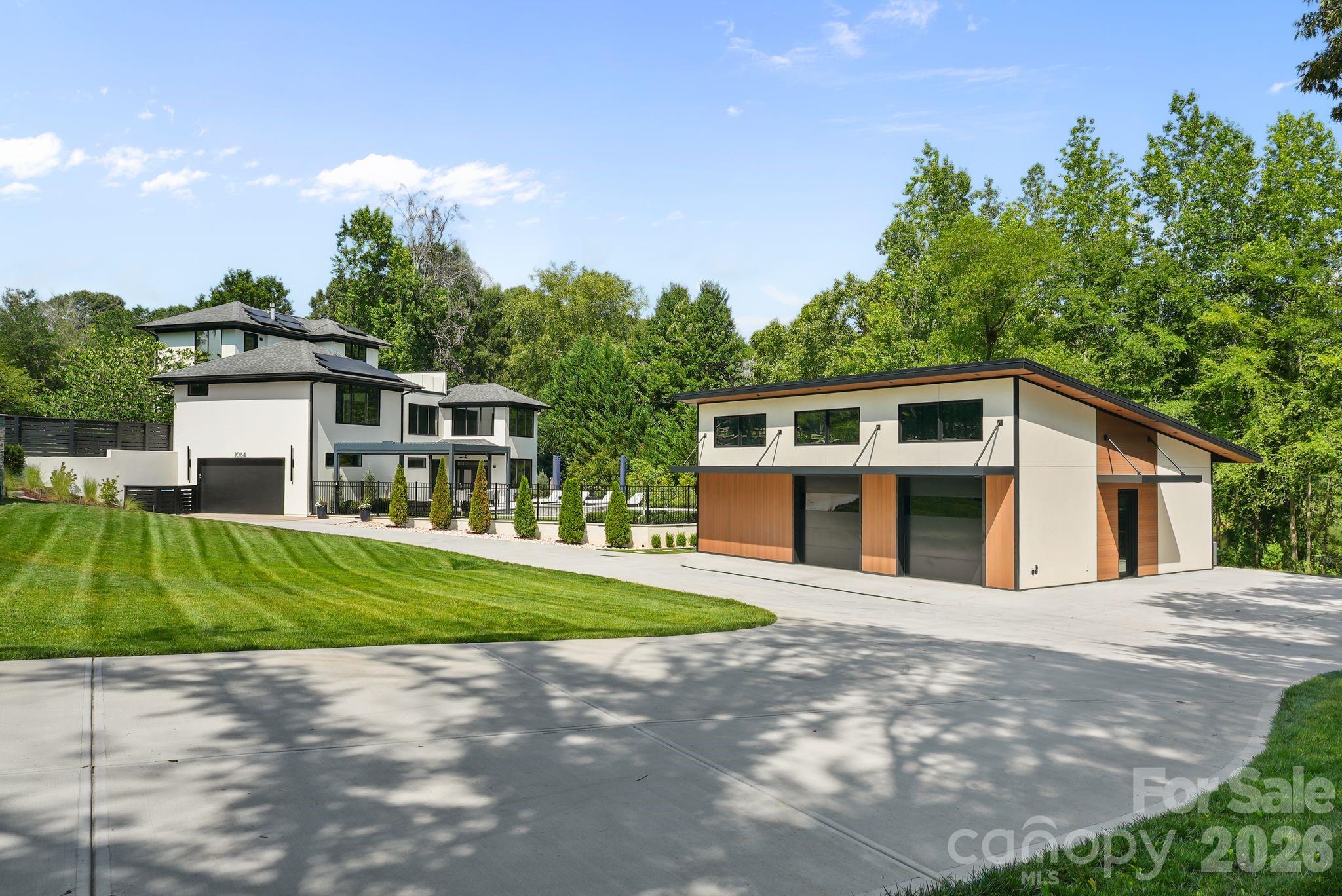 Custom rear-entry garage with oversized circular driveway and gated entry - 1064 Greylyn Drive, Matthews