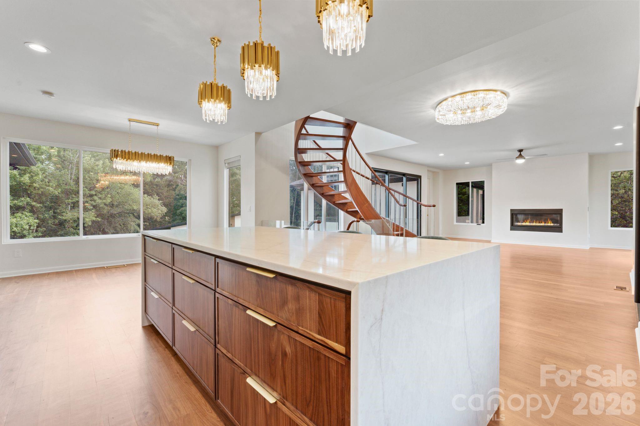 Chef's kitchen with 9-foot waterfall island, walk-in pantry access, and premium finishes - 1064 Greylyn Drive, Matthews