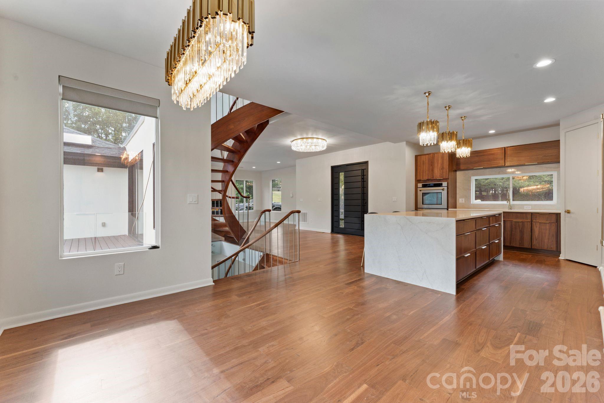 Gourmet kitchen with island seating, custom oak cabinetry, and stainless steel appliances - 1064 Greylyn Drive, Matthews