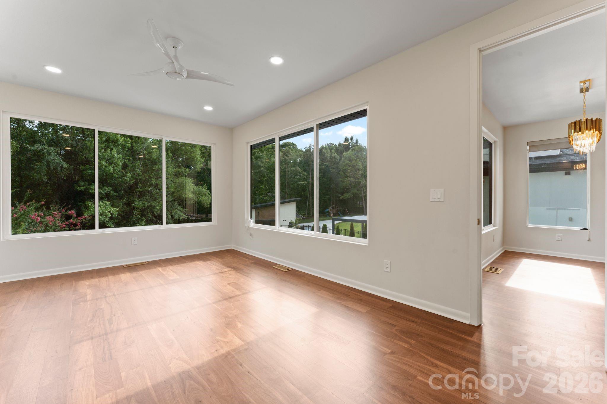 Eat-in kitchen and breakfast nook with designer lighting and oak hardwood floors - 1064 Greylyn Drive, Matthews