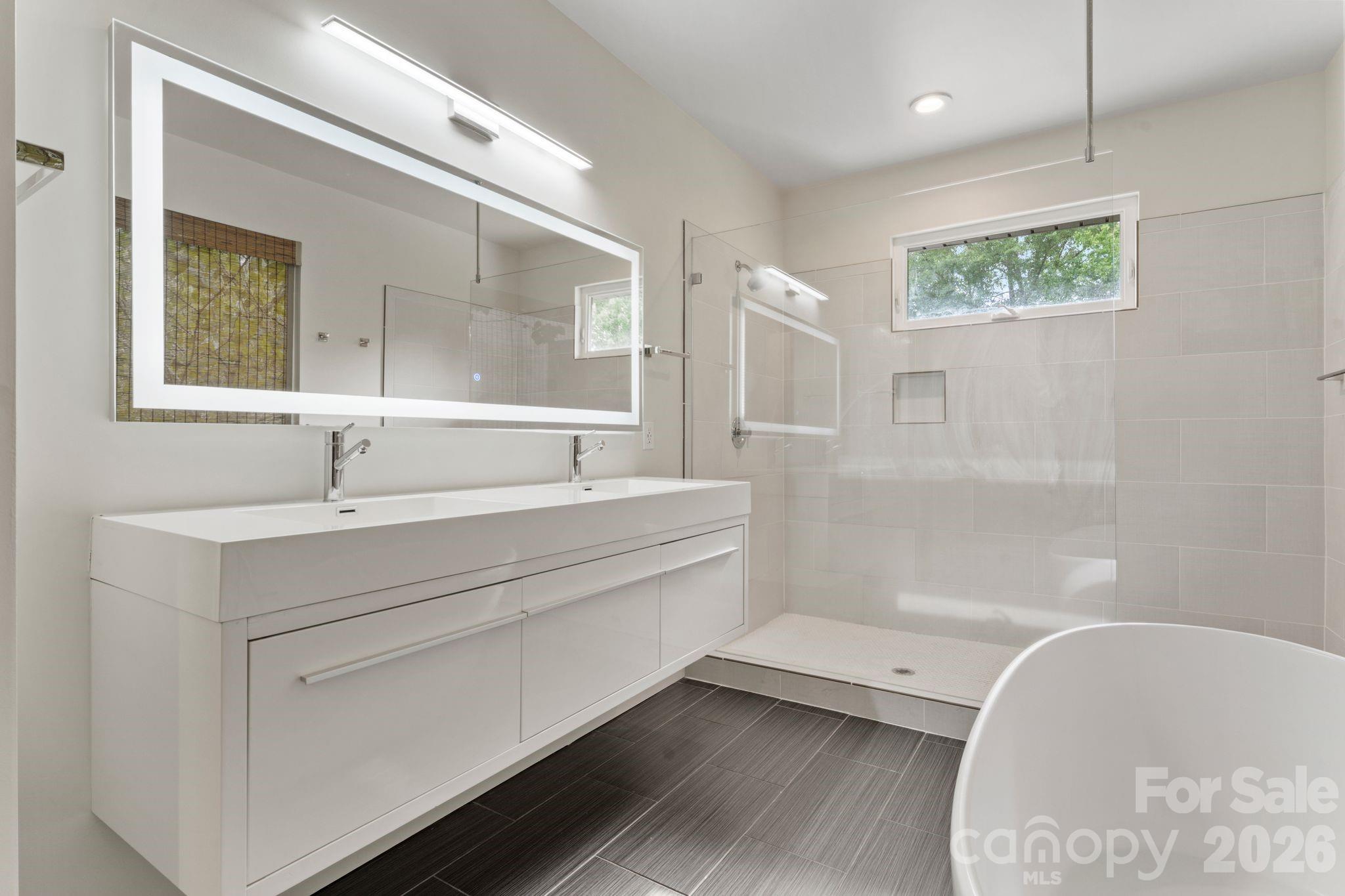 Luxury primary spa bathroom with oversized walk-in shower and freestanding soaker tub - 1064 Greylyn Drive, Matthews