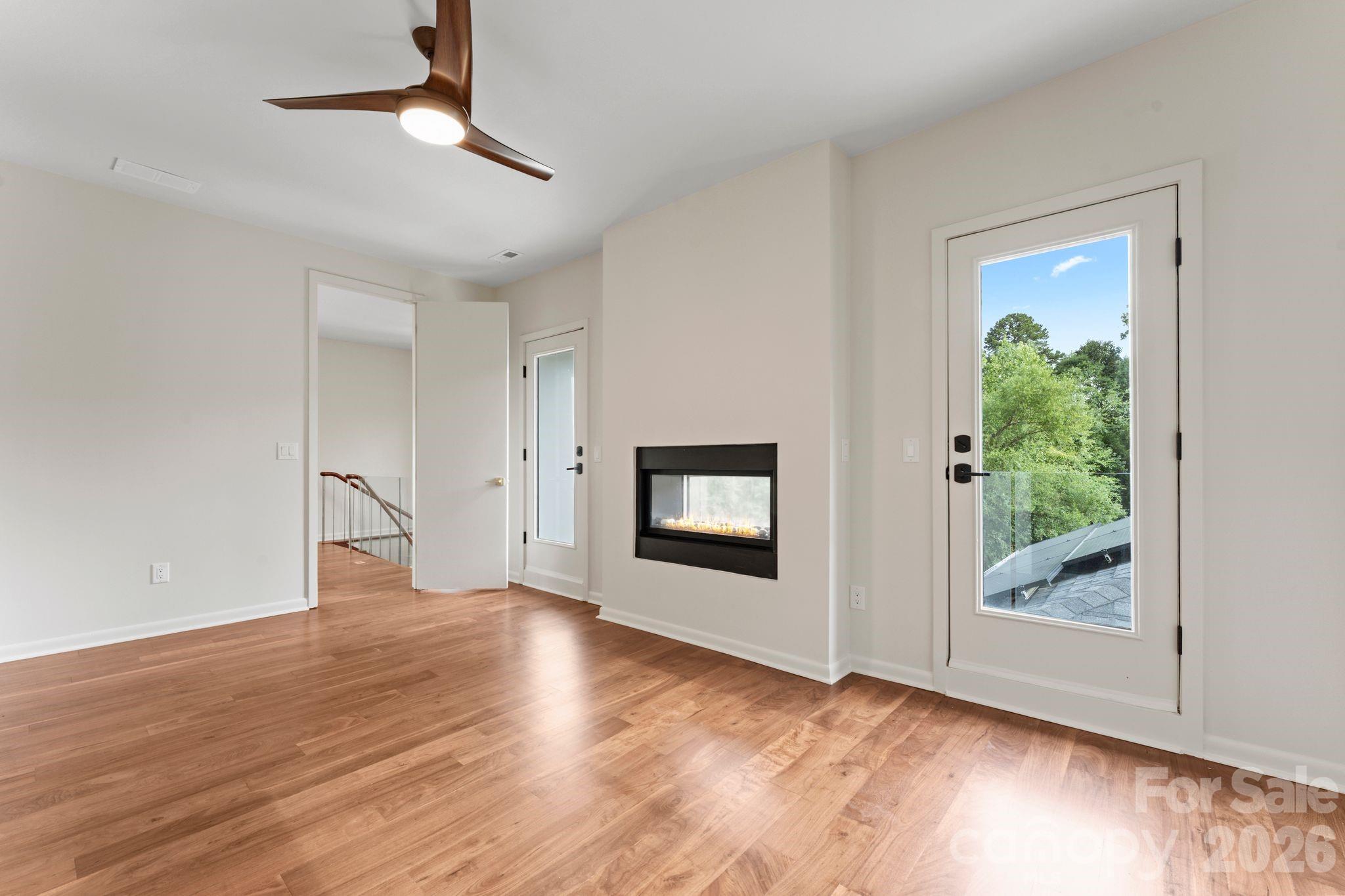 Second-floor guest suite with private patio, gas fireplace, and full en-suite bathroom - 1064 Greylyn Drive, Matthews