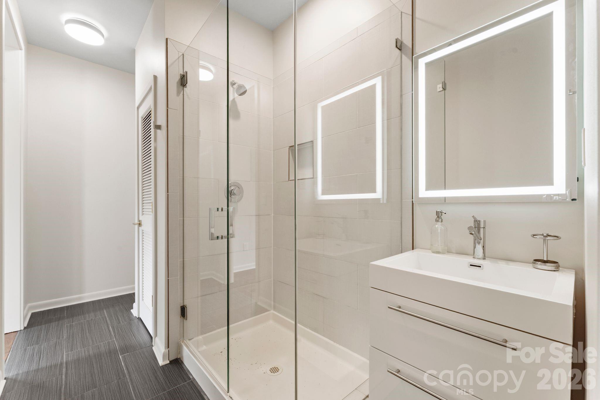 Second-floor en-suite guest bathroom with modern finishes - 1064 Greylyn Drive, Matthews