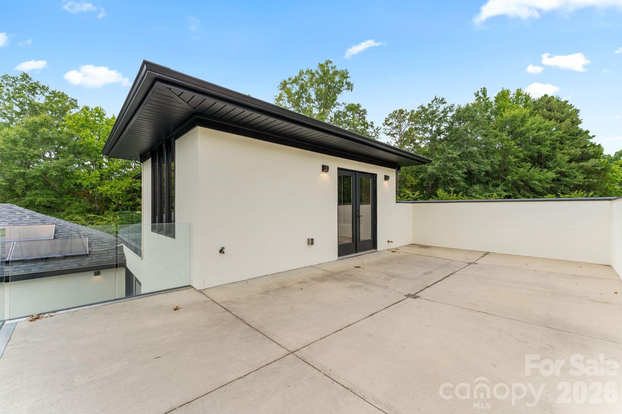 Rooftop terrace with paneled glass walls and panoramic pool views - 1064 Greylyn Drive, Matthews