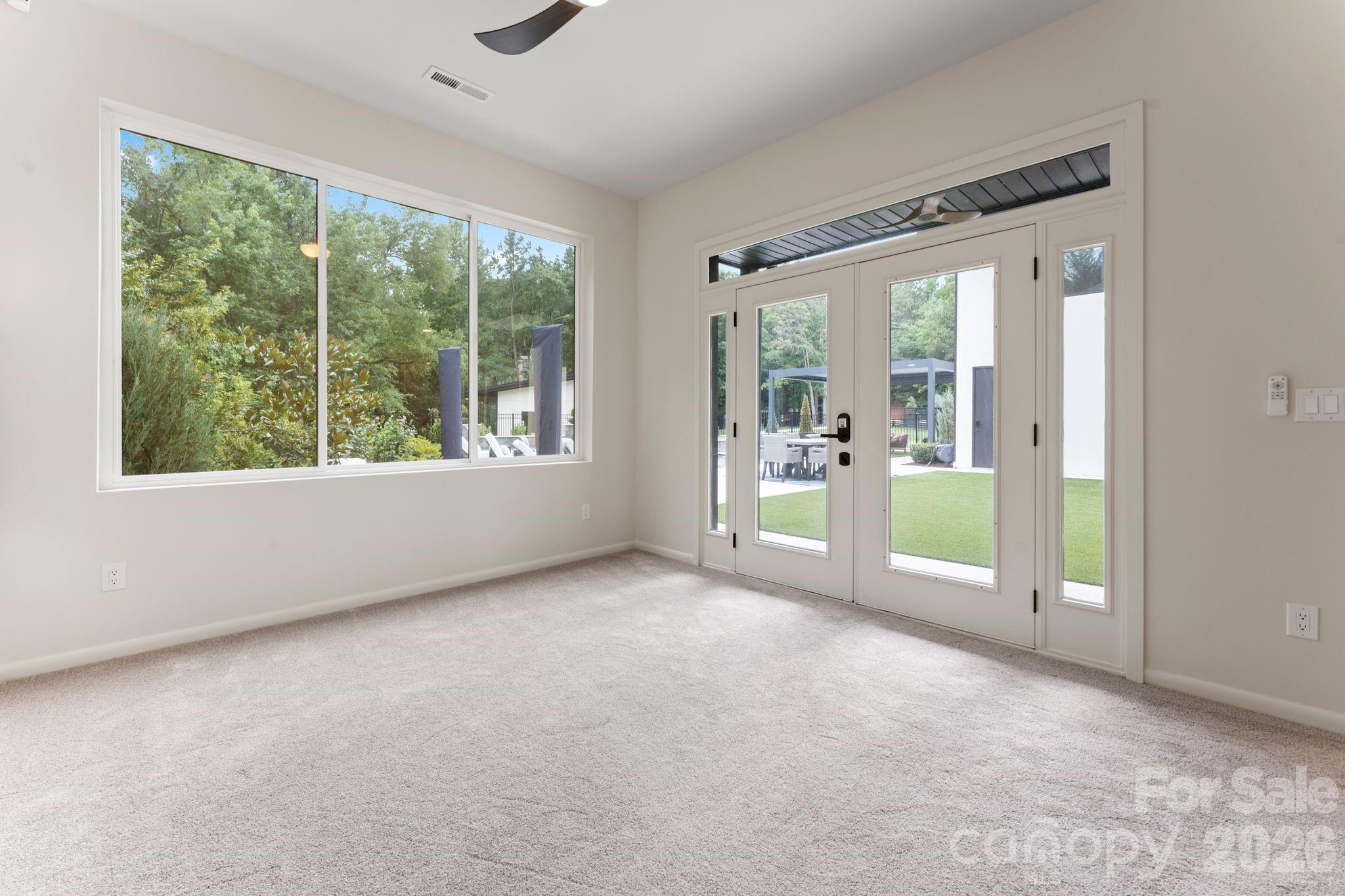 Ground-floor guest suite / in-law suite with private walkout to pool and en-suite spa bath with walk-in shower - 1064 Greylyn Drive, Matthews