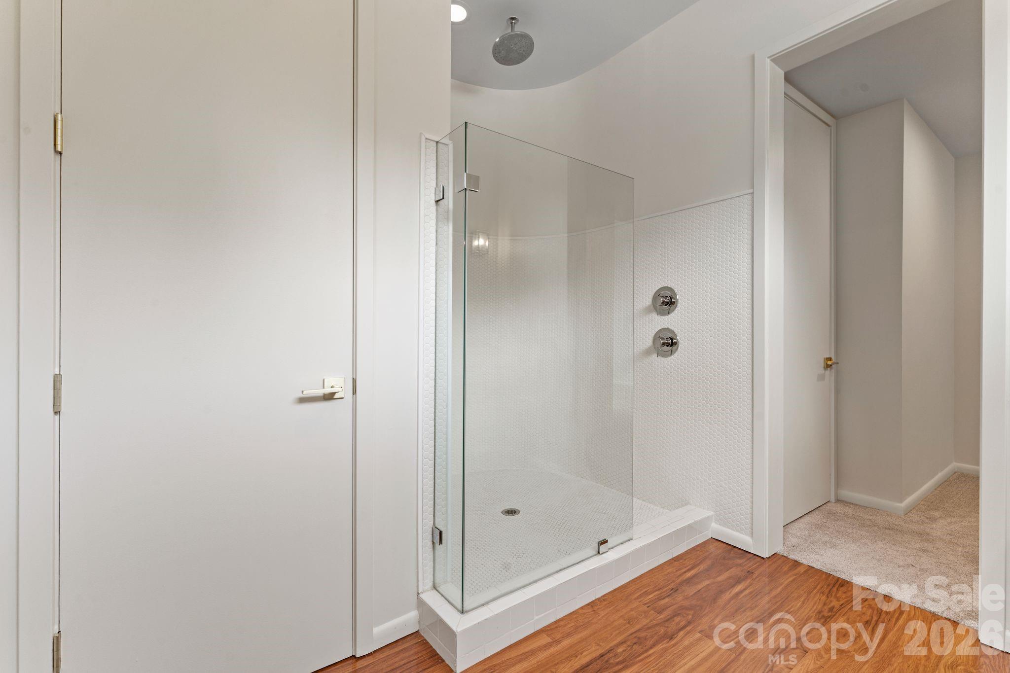 Lower-level guest suite with private walkout, spa bath, and independent access — ideal for multi-generational living - 1064 Greylyn Drive, Matthews