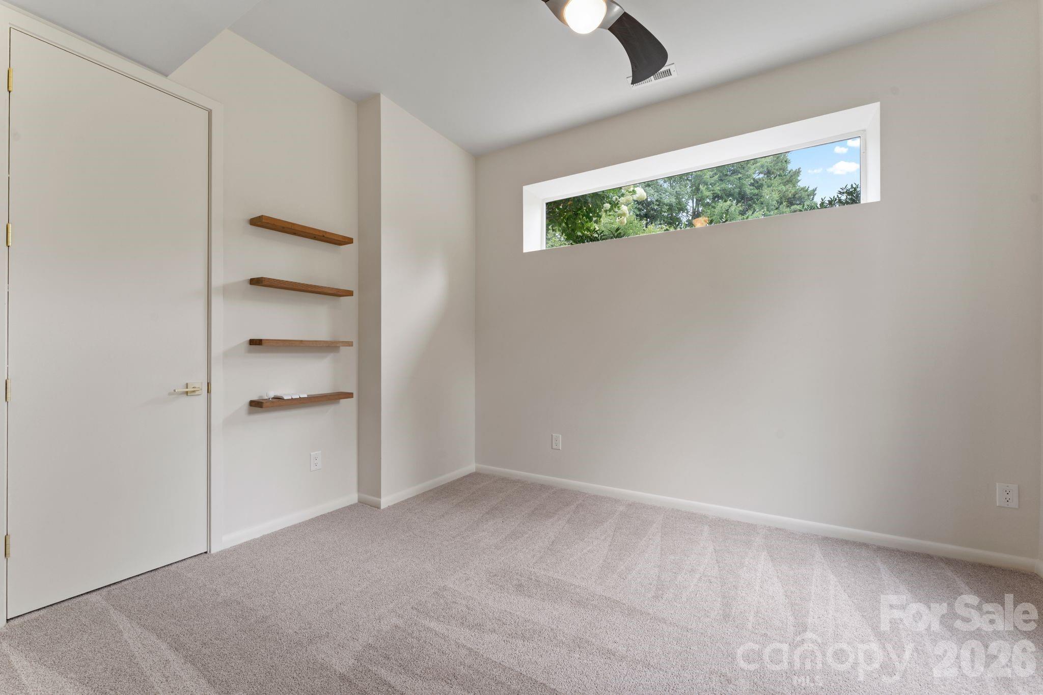 Ground-floor guest bedroom with natural light - 1064 Greylyn Drive, Matthews