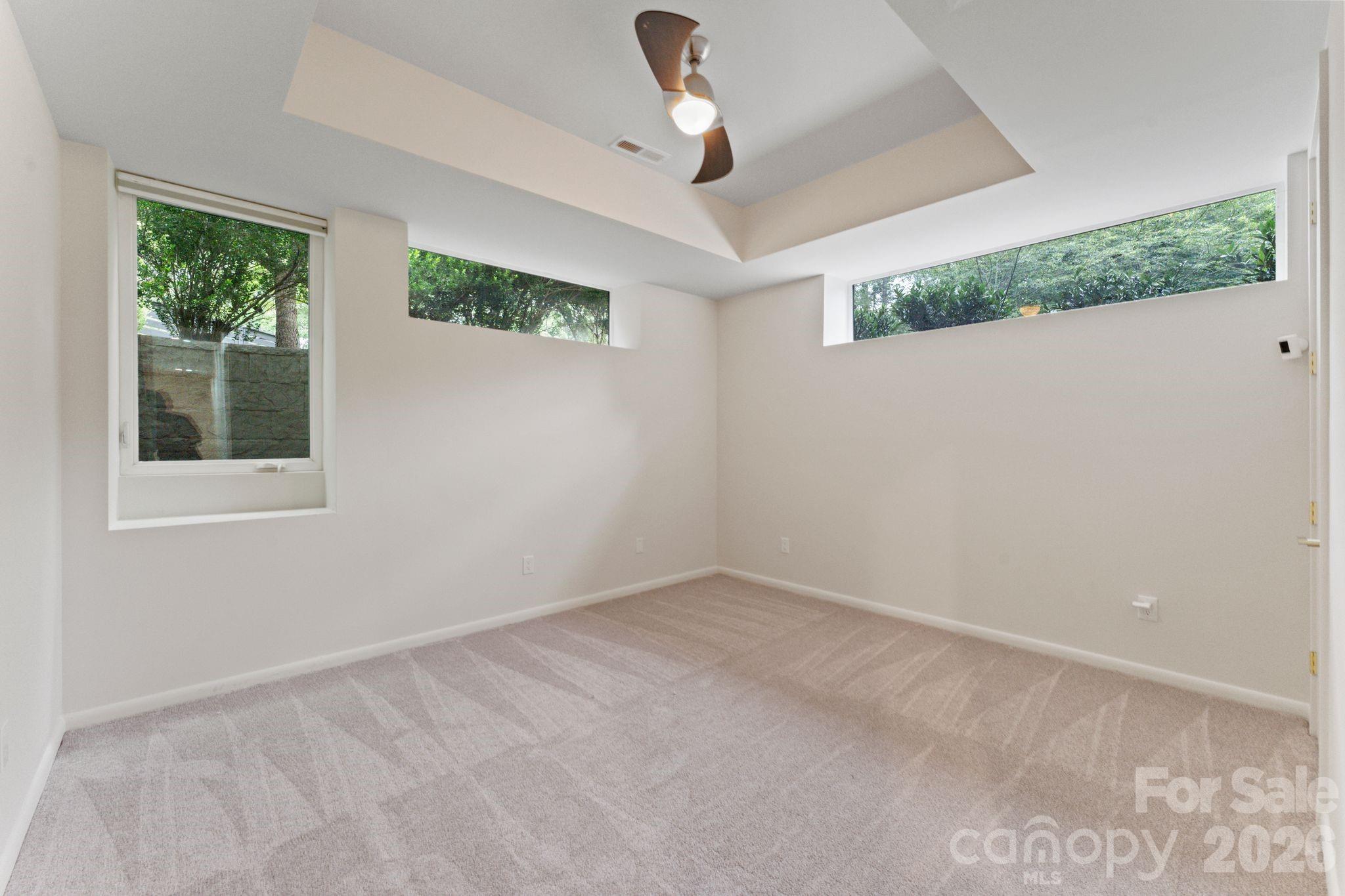 Ground-floor full guest bathroom with modern fixtures - 1064 Greylyn Drive, Matthews