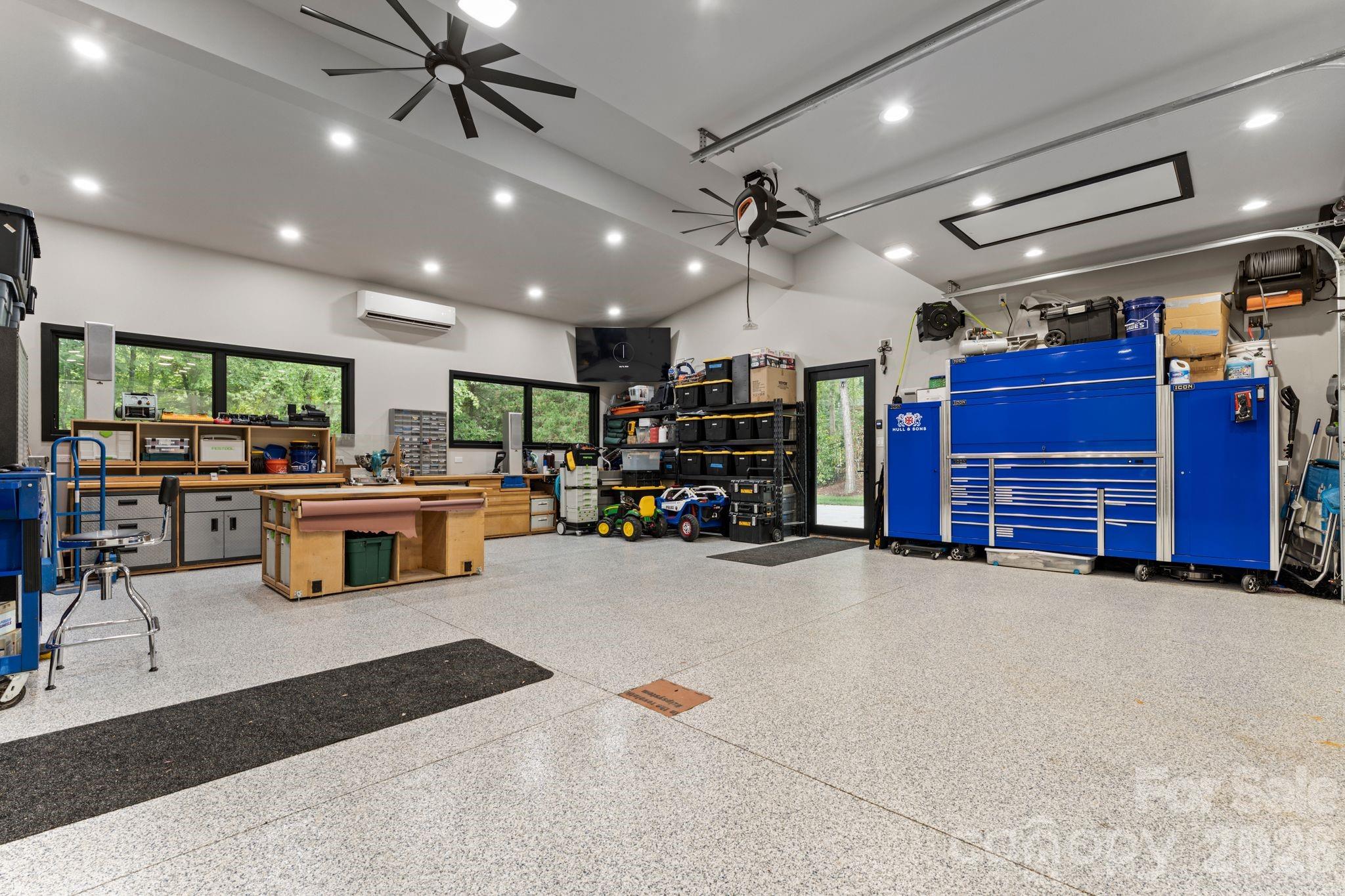 Oversized heated and cooled garage with polyaspartic floor coating, EV charger, hot/cold faucets, and plumbed pressure washer - 1064 Greylyn Drive, Matthews