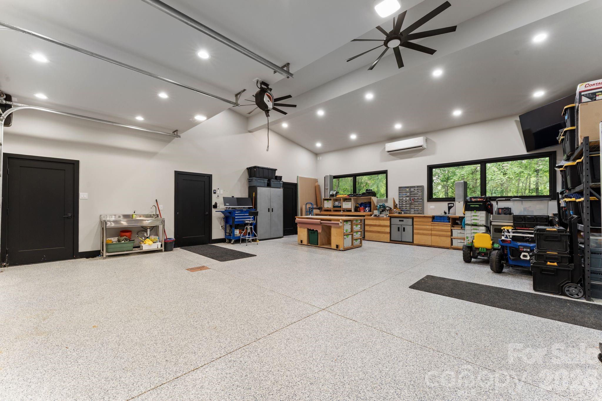 Oversized heated and cooled garage with polyaspartic floor coating, EV charger, hot/cold faucets, and plumbed pressure washer - 1064 Greylyn Drive, Matthews