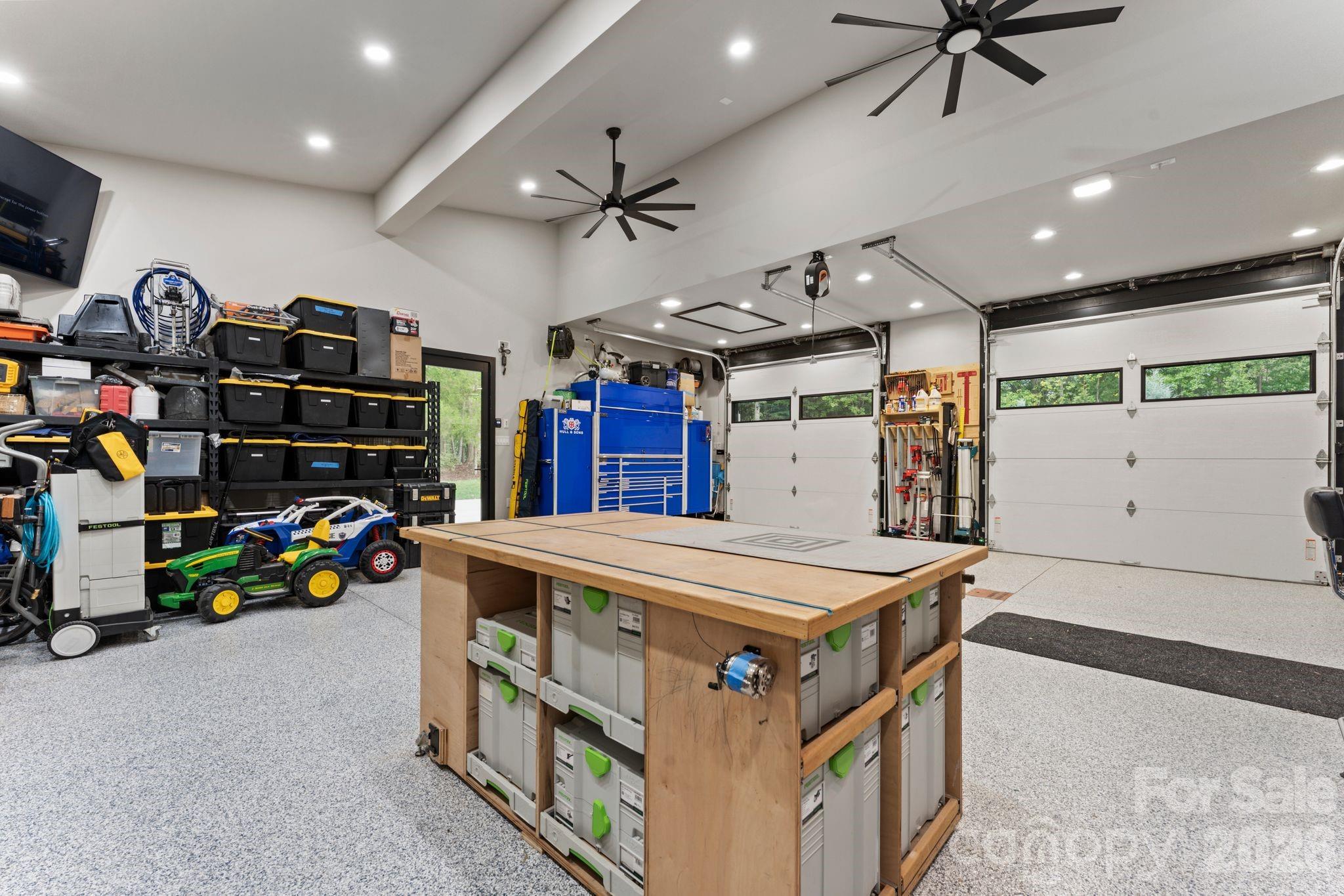 Climate-controlled finished garage with EV charging, epoxy-style polyaspartic floors, and workshop features - 1064 Greylyn Drive, Matthews