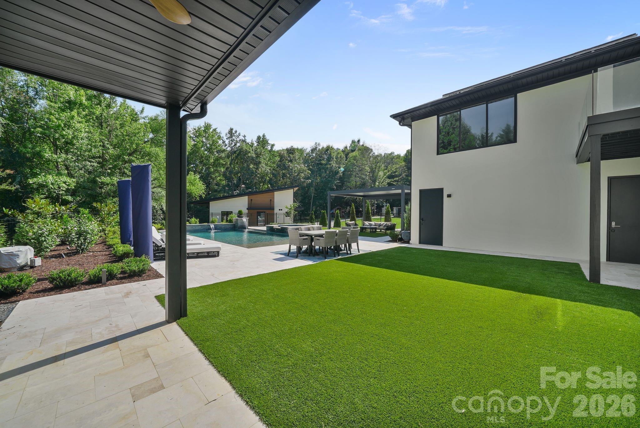 Resort style backyard with multiple turf areas and entertaining spaces - 1064 Greylyn Drive, Matthews