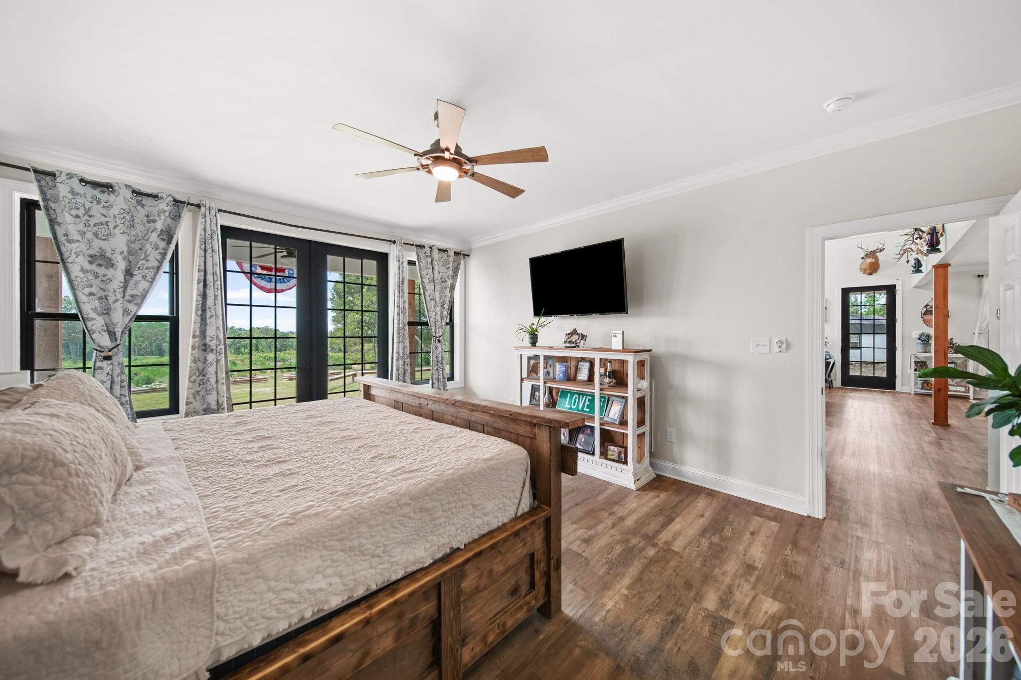Main level primary bedroom suite opens to the back porch - 1726 Old Cheraw Highway, Rockingham