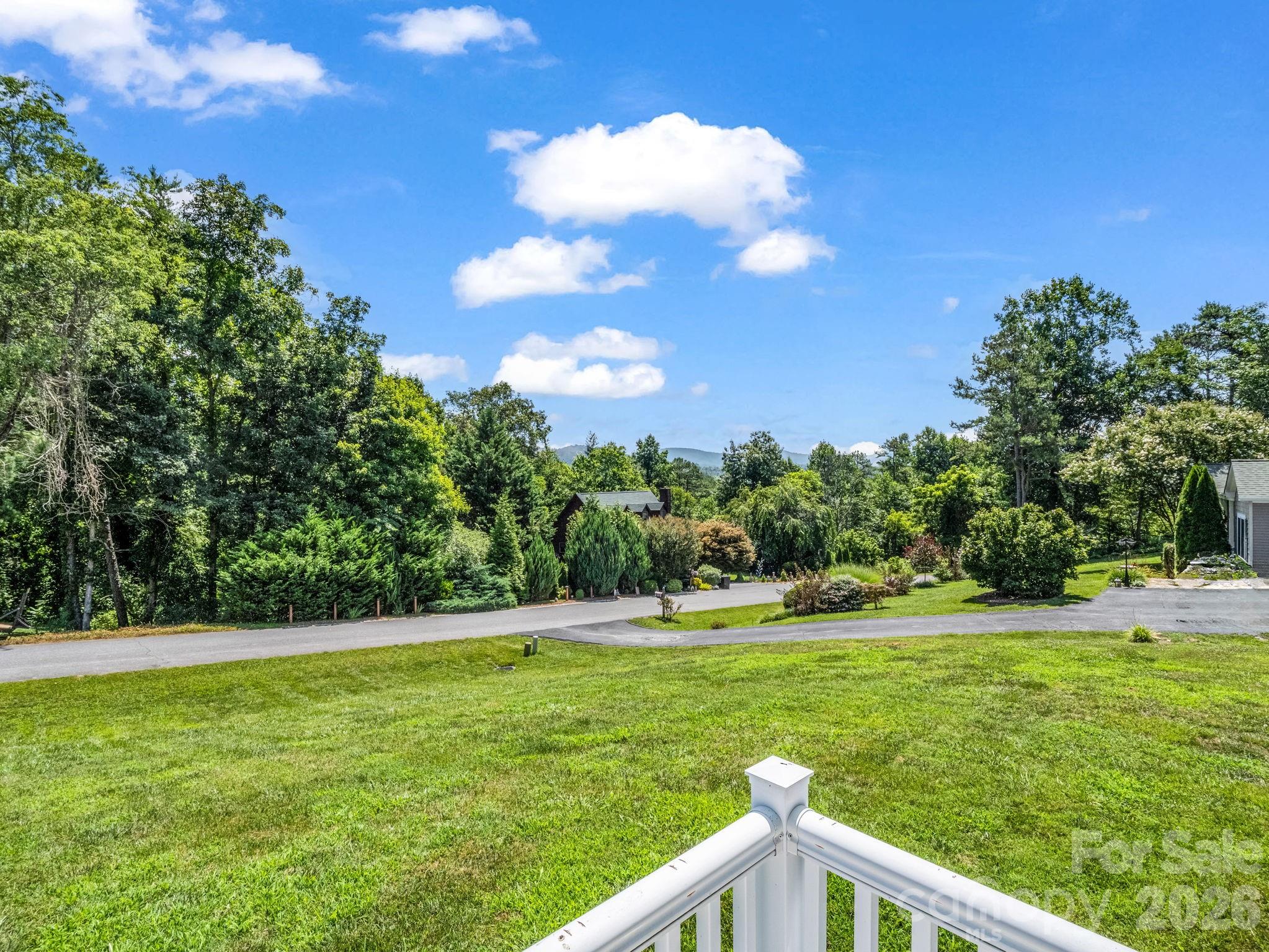 This East facing home gives you a front row seat to gorgeous sunrises over the mountains and year round, long-range mountain views. - 355 Hidden Meadow Drive, Hendersonville