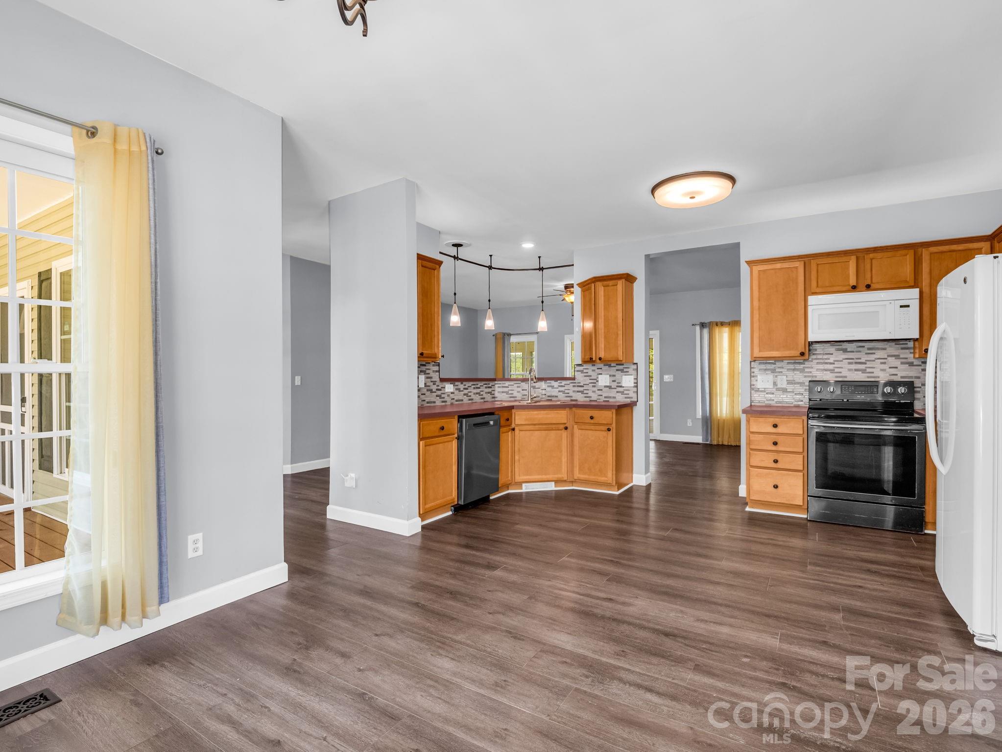 View of kitchen from dining area; open layout is perfect for entertaining. - 355 Hidden Meadow Drive, Hendersonville