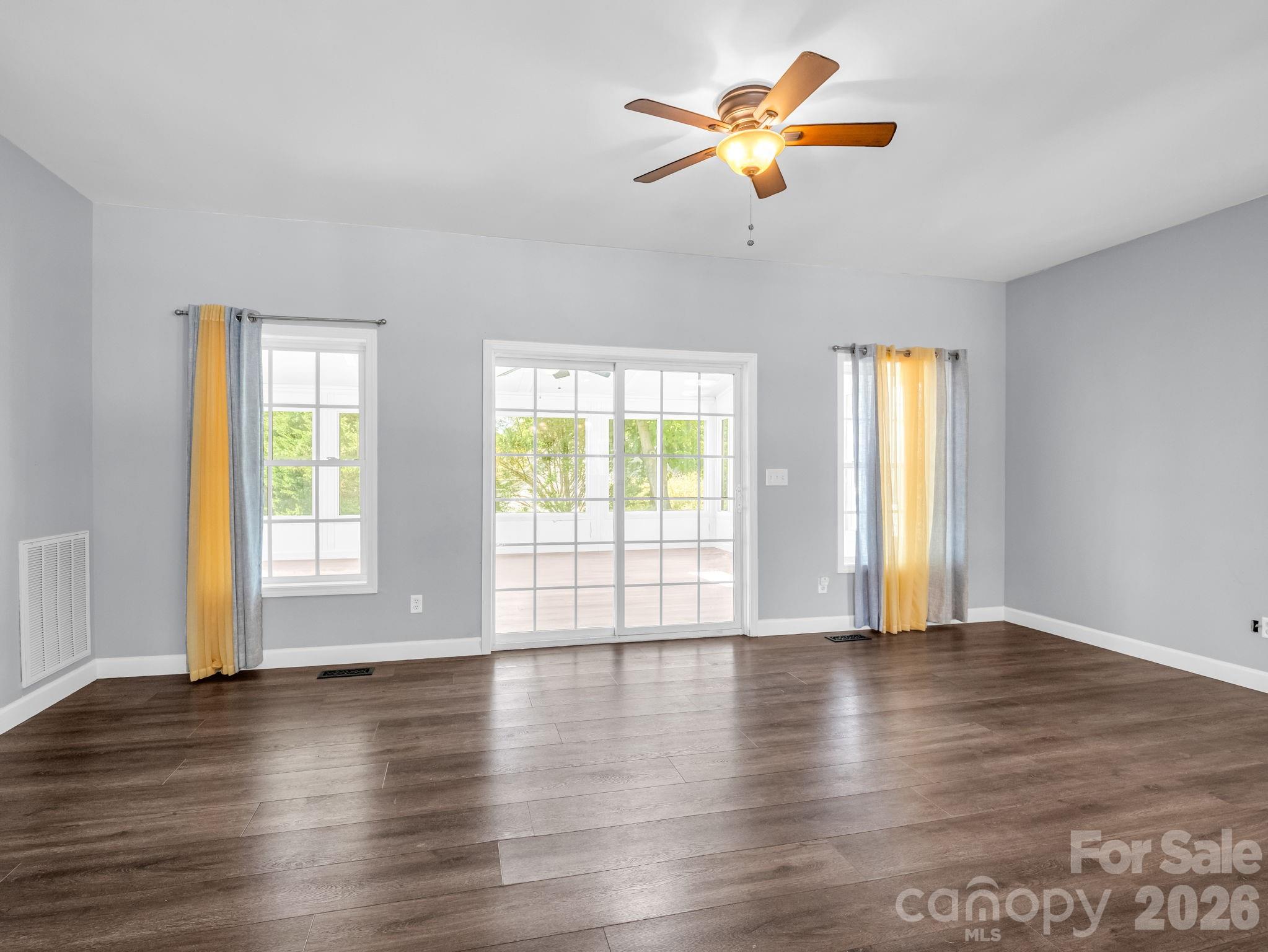 Living area with access to newly renovated 29 x 13 sunroom. - 355 Hidden Meadow Drive, Hendersonville