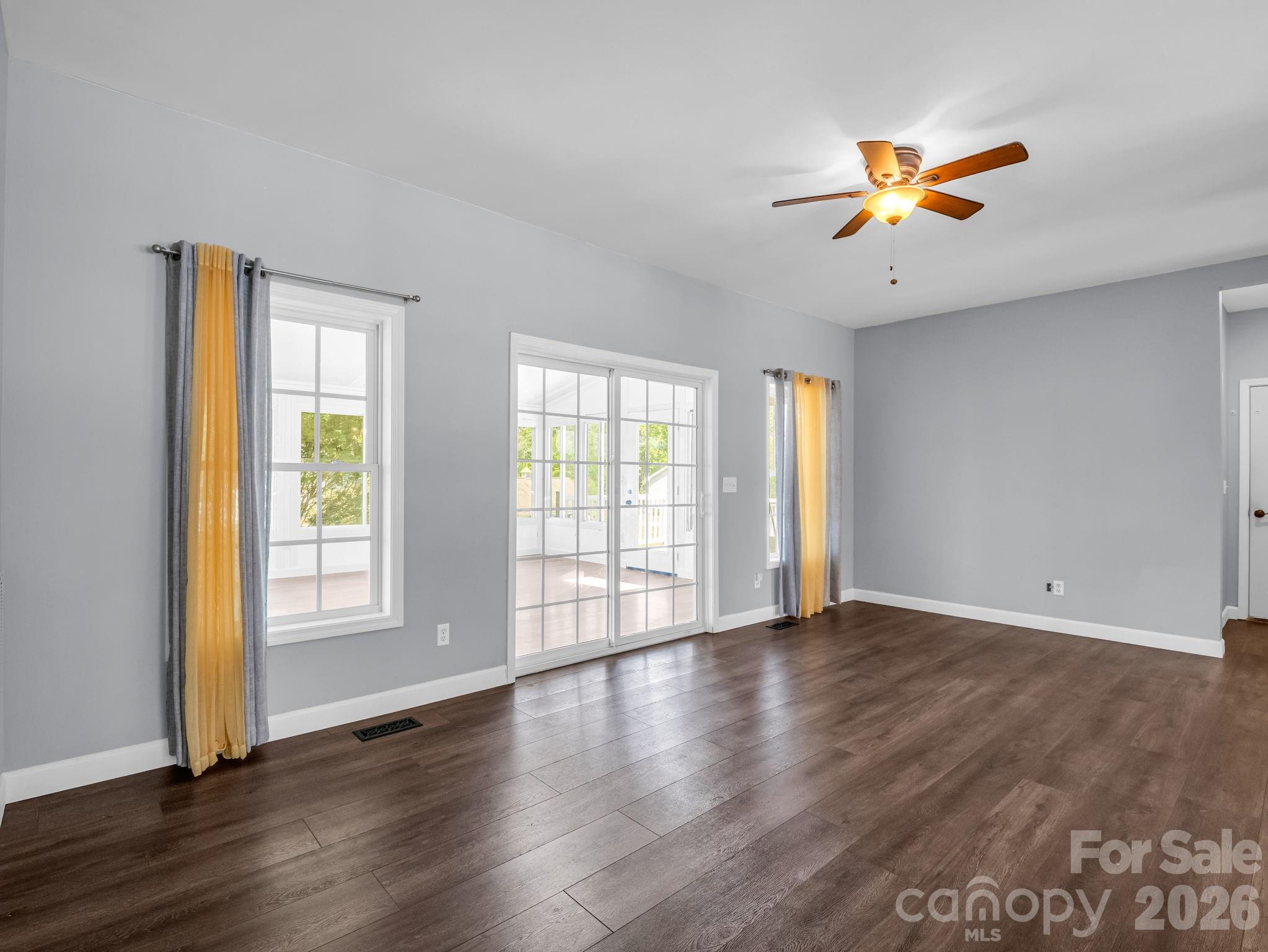 Another view of the living area; to the right is a hall that leads to the laundry room and large 2-car garage. - 355 Hidden Meadow Drive, Hendersonville